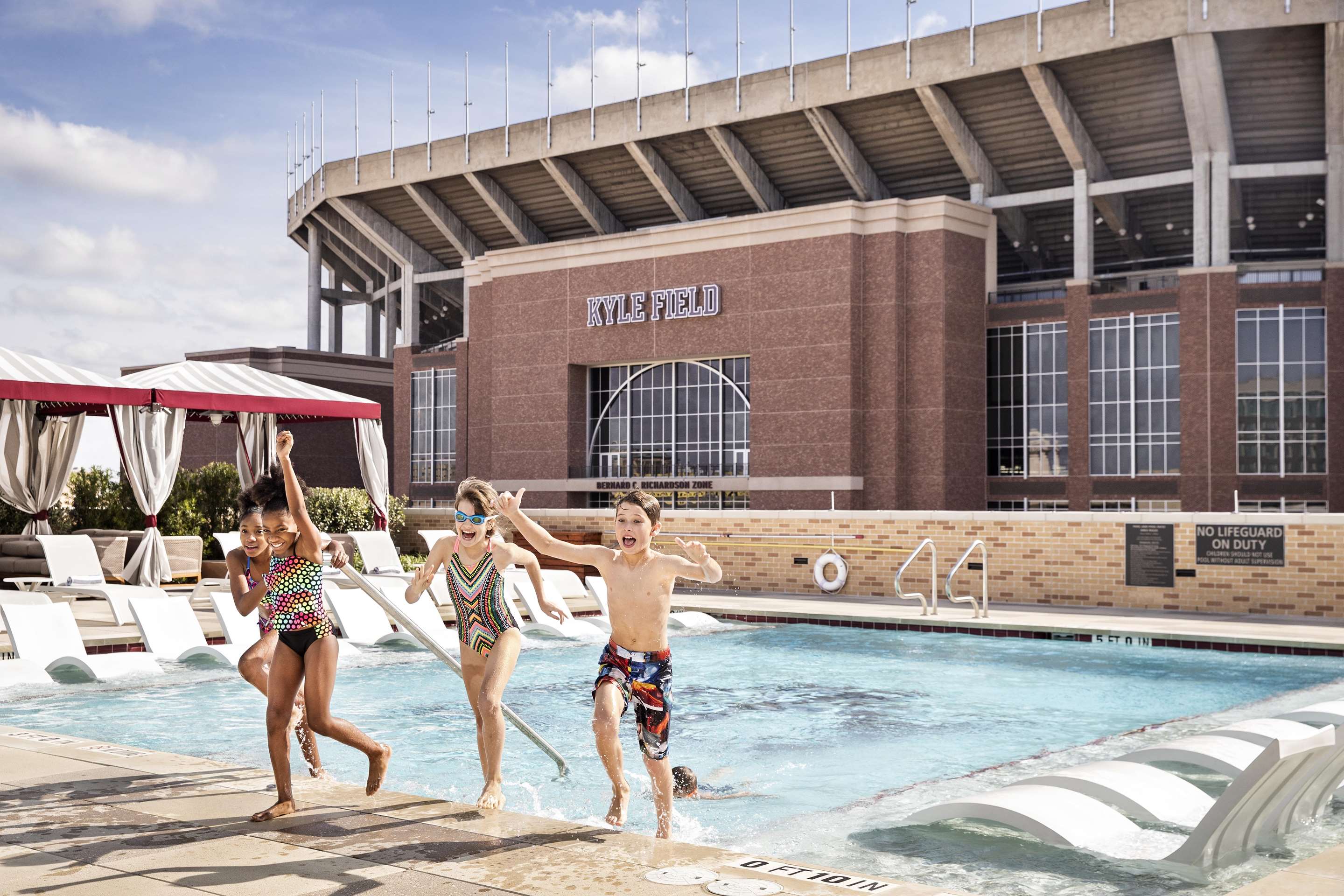 kids at rooftop pool | Texas A&M Hotel and Conference Center