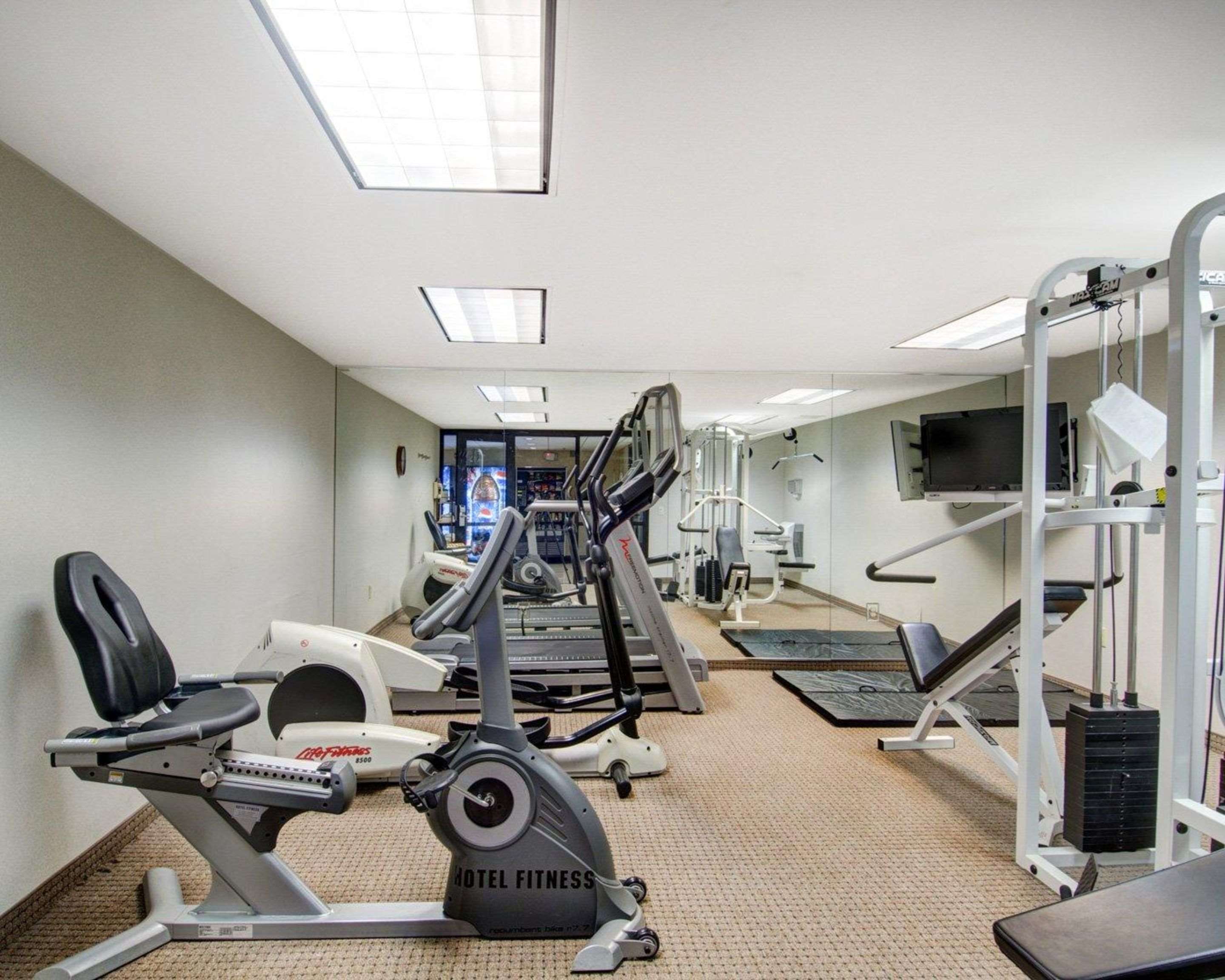 Exercise room with cardio equipment and weights | Spark by Hilton Woburn Boston