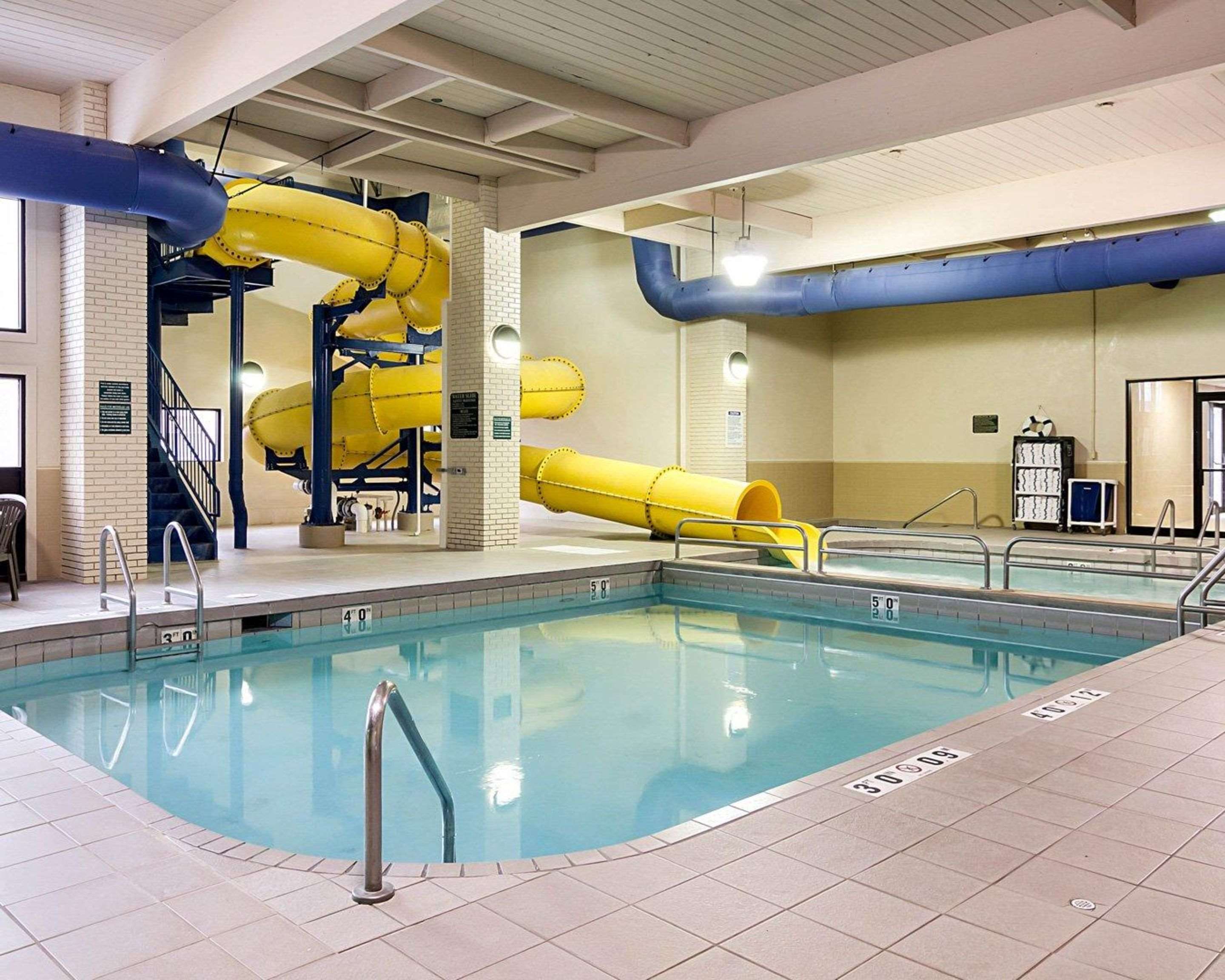 Indoor pool with water slide | Quality Inn & Suites Conference Center and Water Park