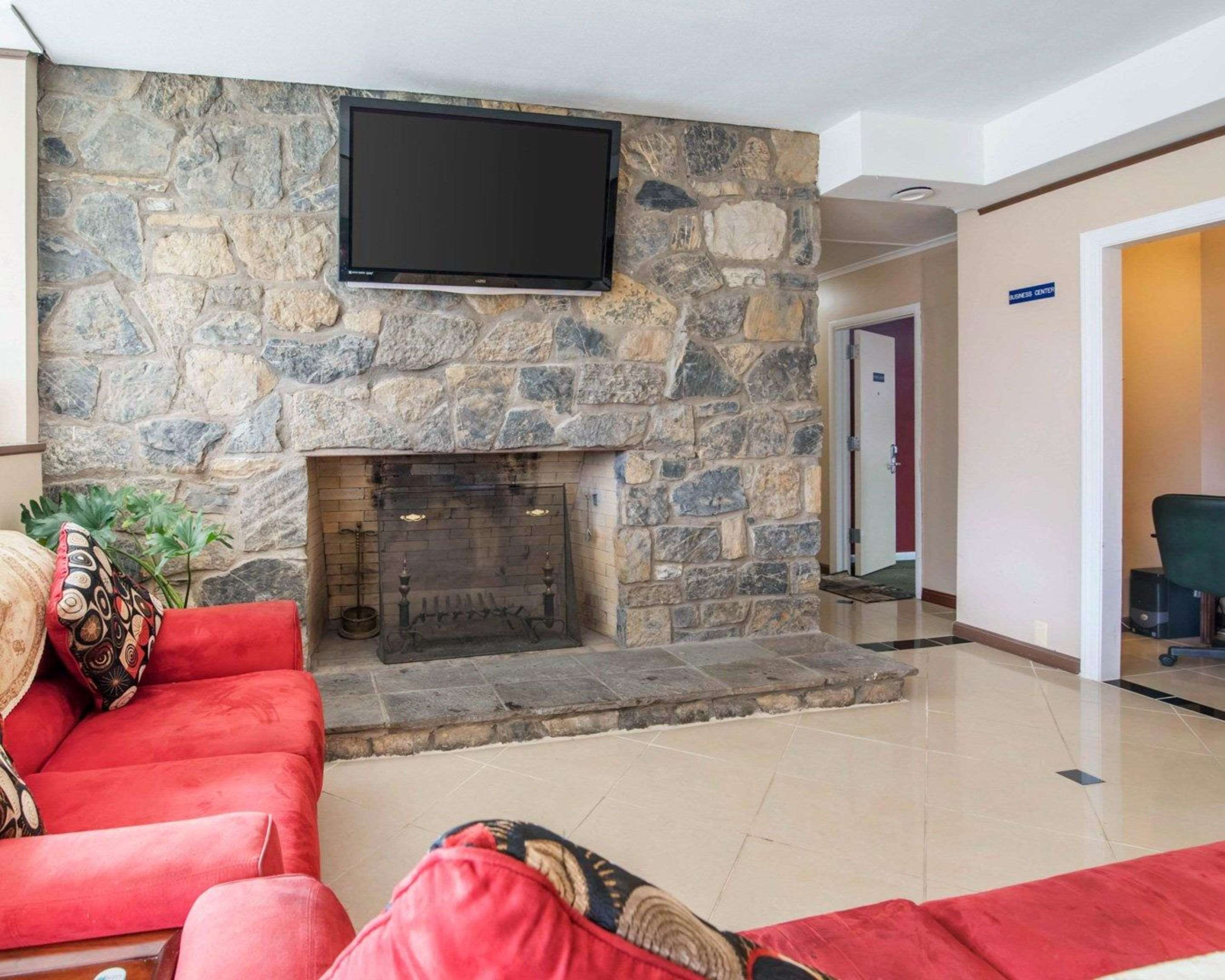 Relax by the fireplace in the lobby | Rodeway Inn Skytop