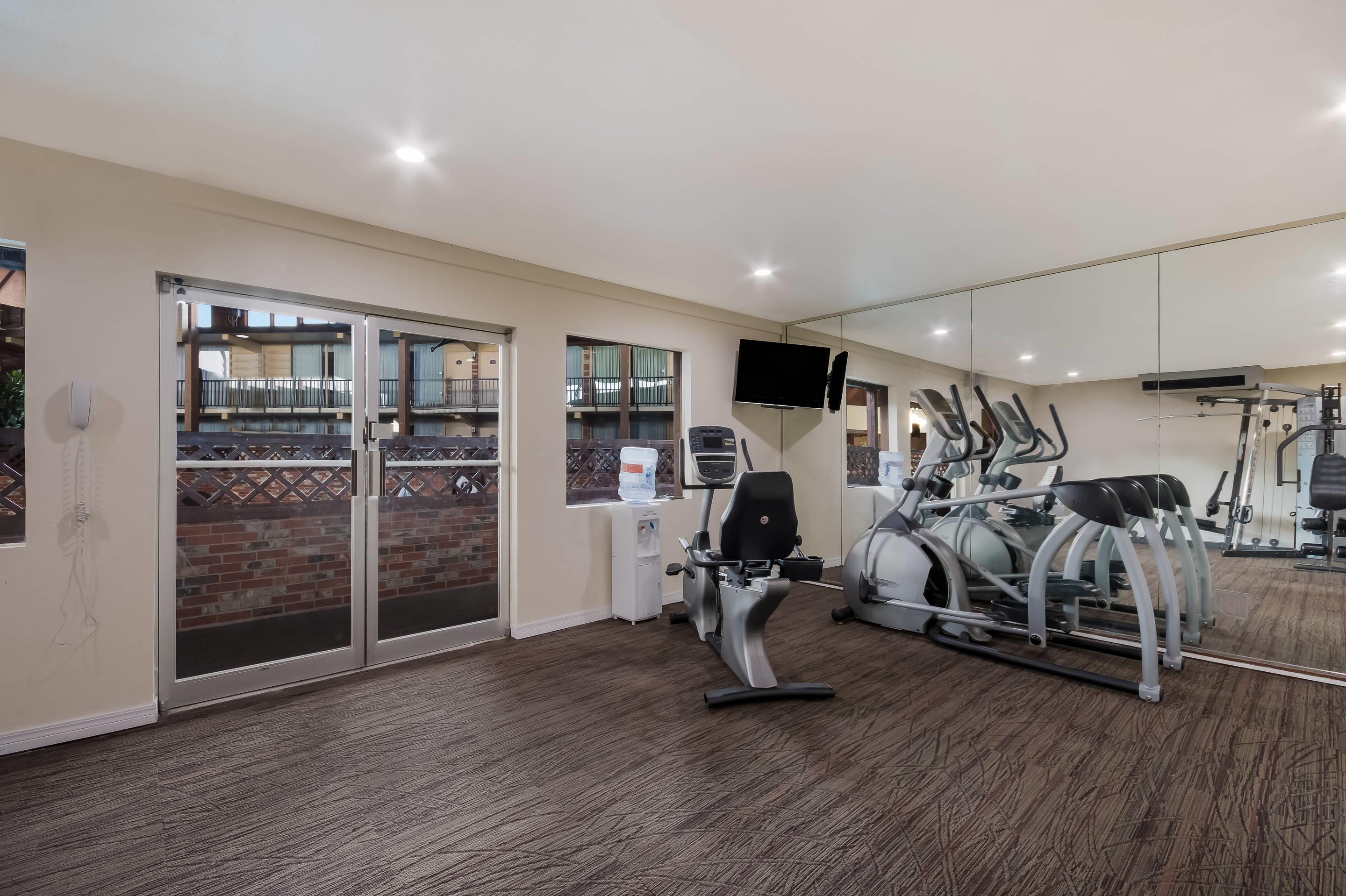 Exercise room with cardio equipment and weights