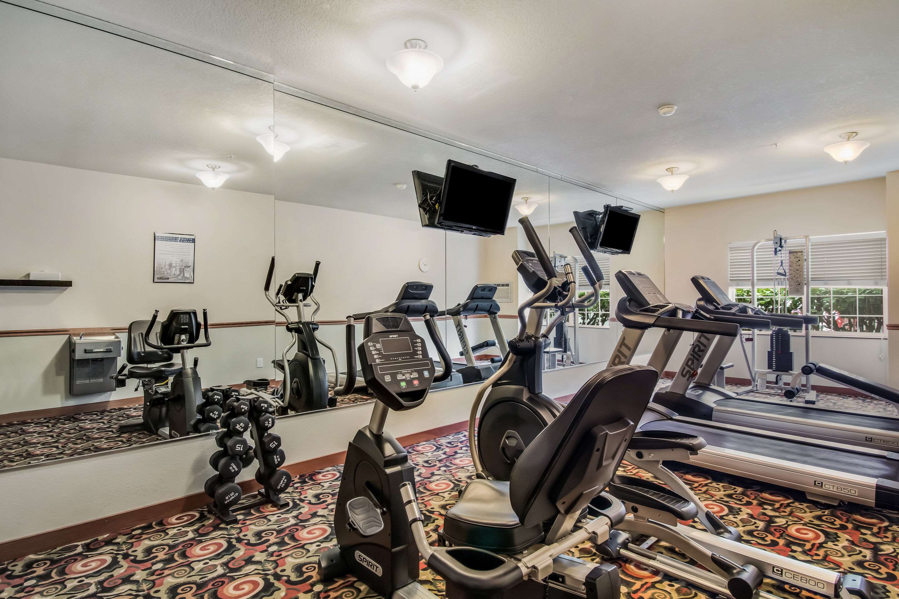 Exercise room with cardio equipment | Quality Inn