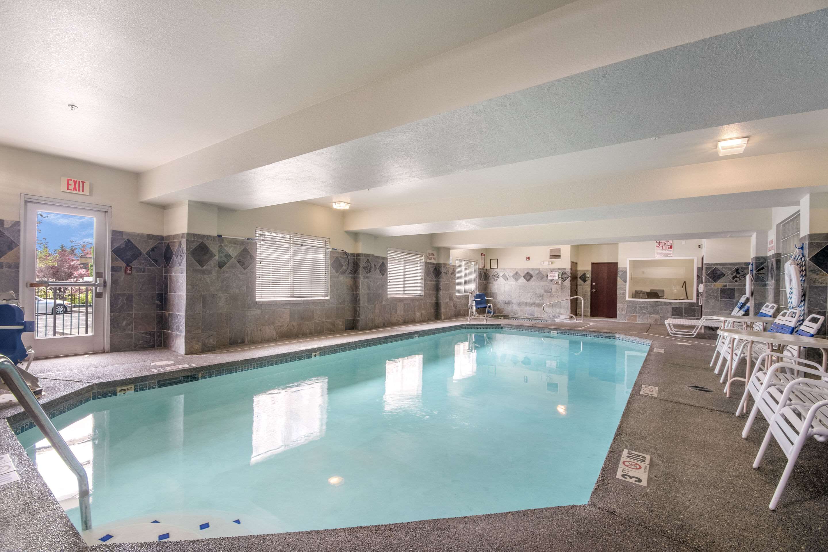 Relax by the pool | Quality Inn