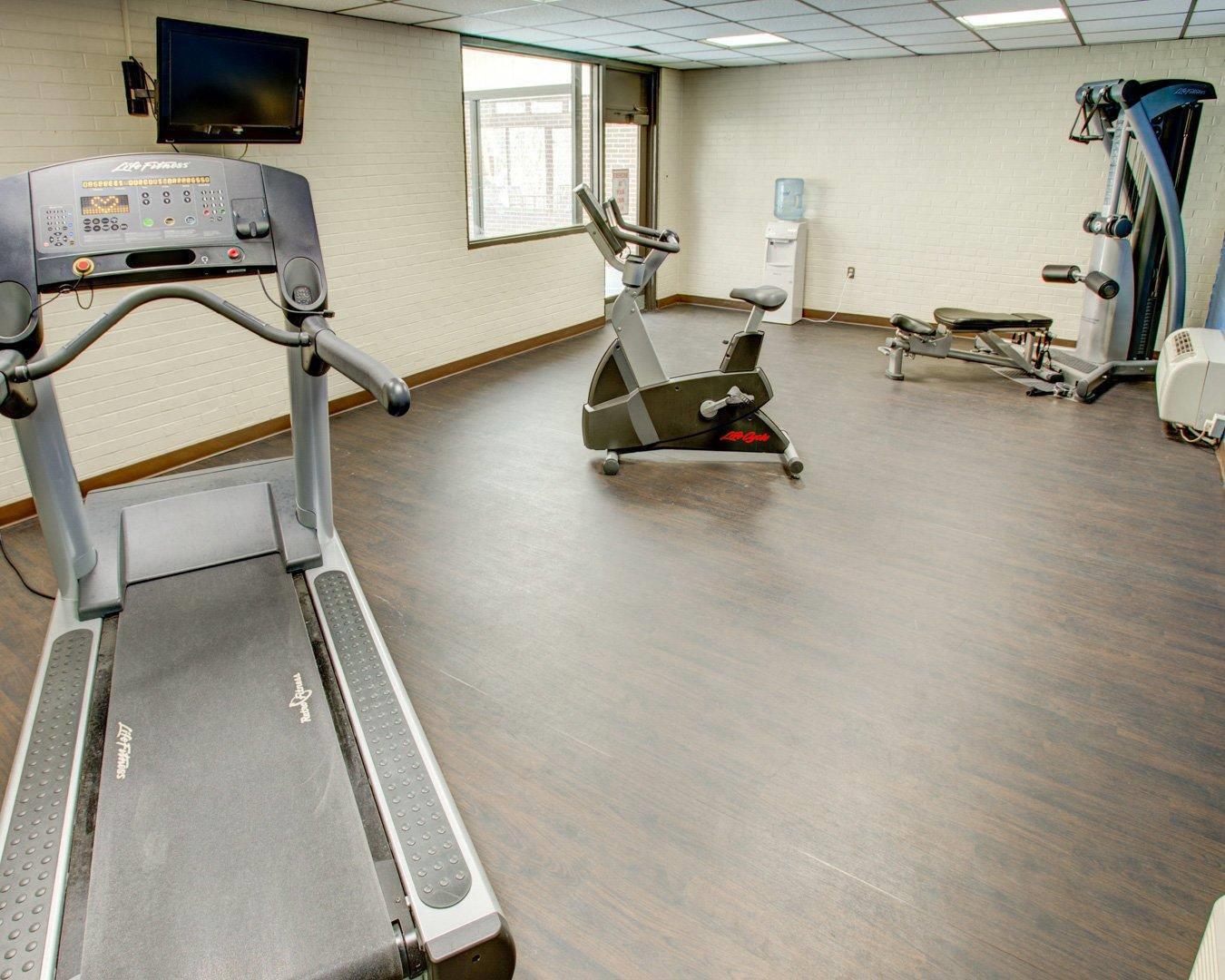 Fitness center with cardio equipment and weights | Comfort Inn Conference Center