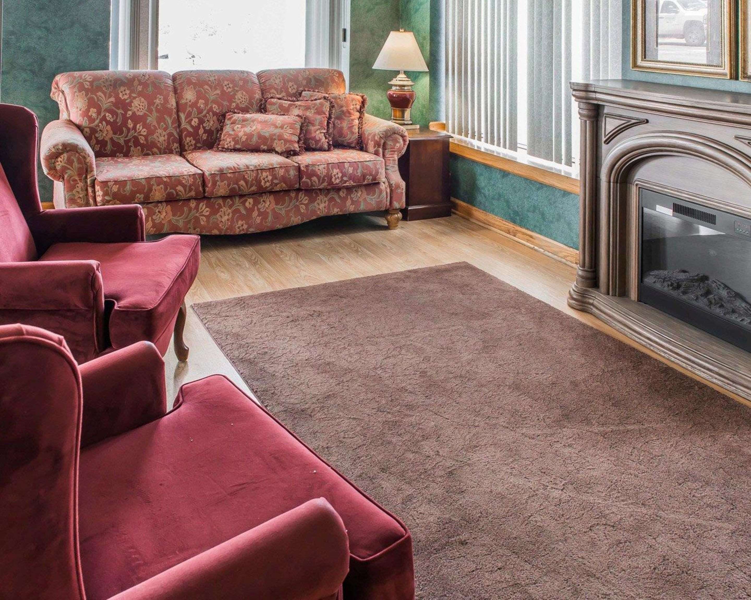 Relax by the fireplace in the lobby | Quality Inn