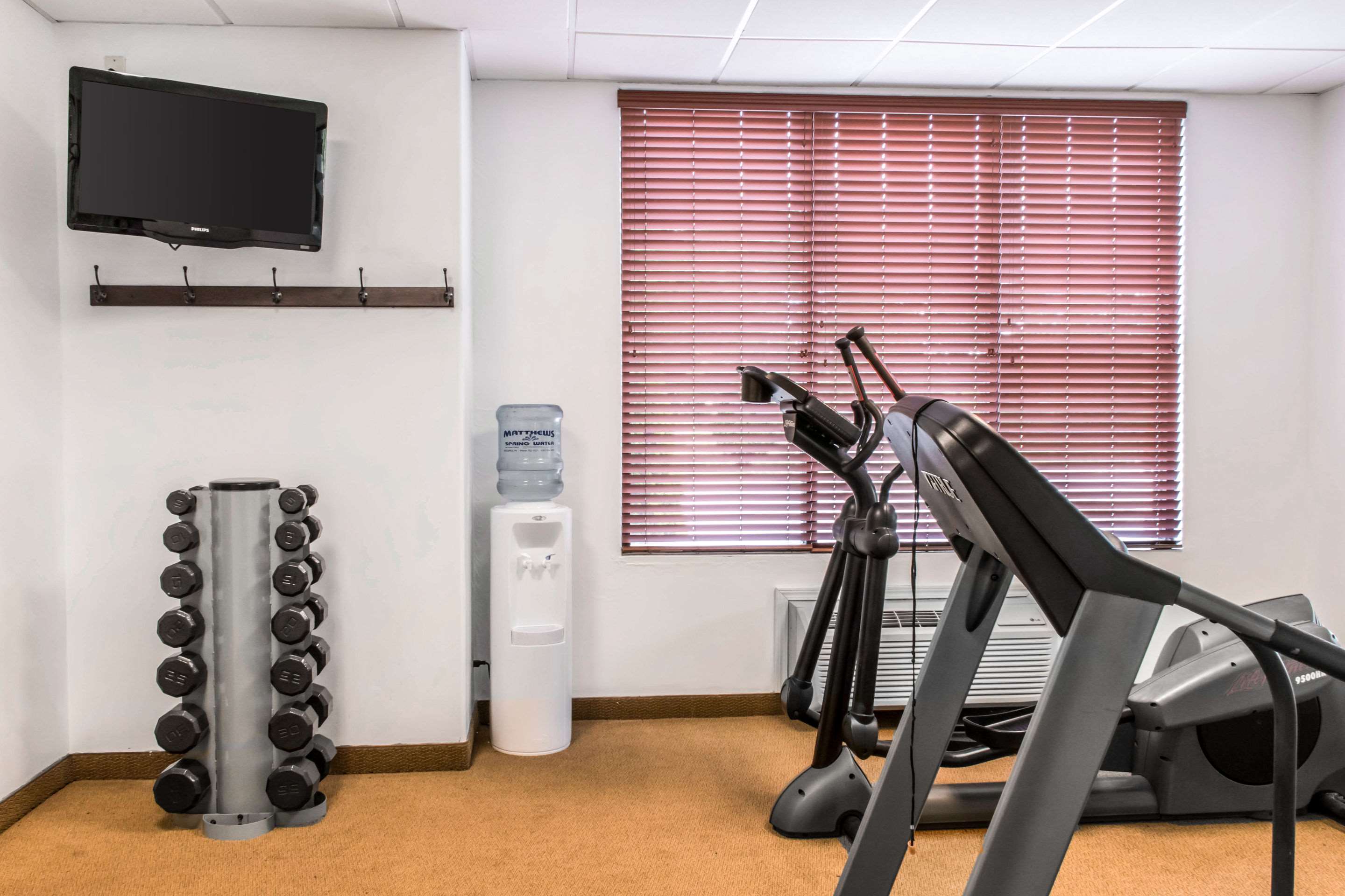 Exercise room with cardio equipment and weights
