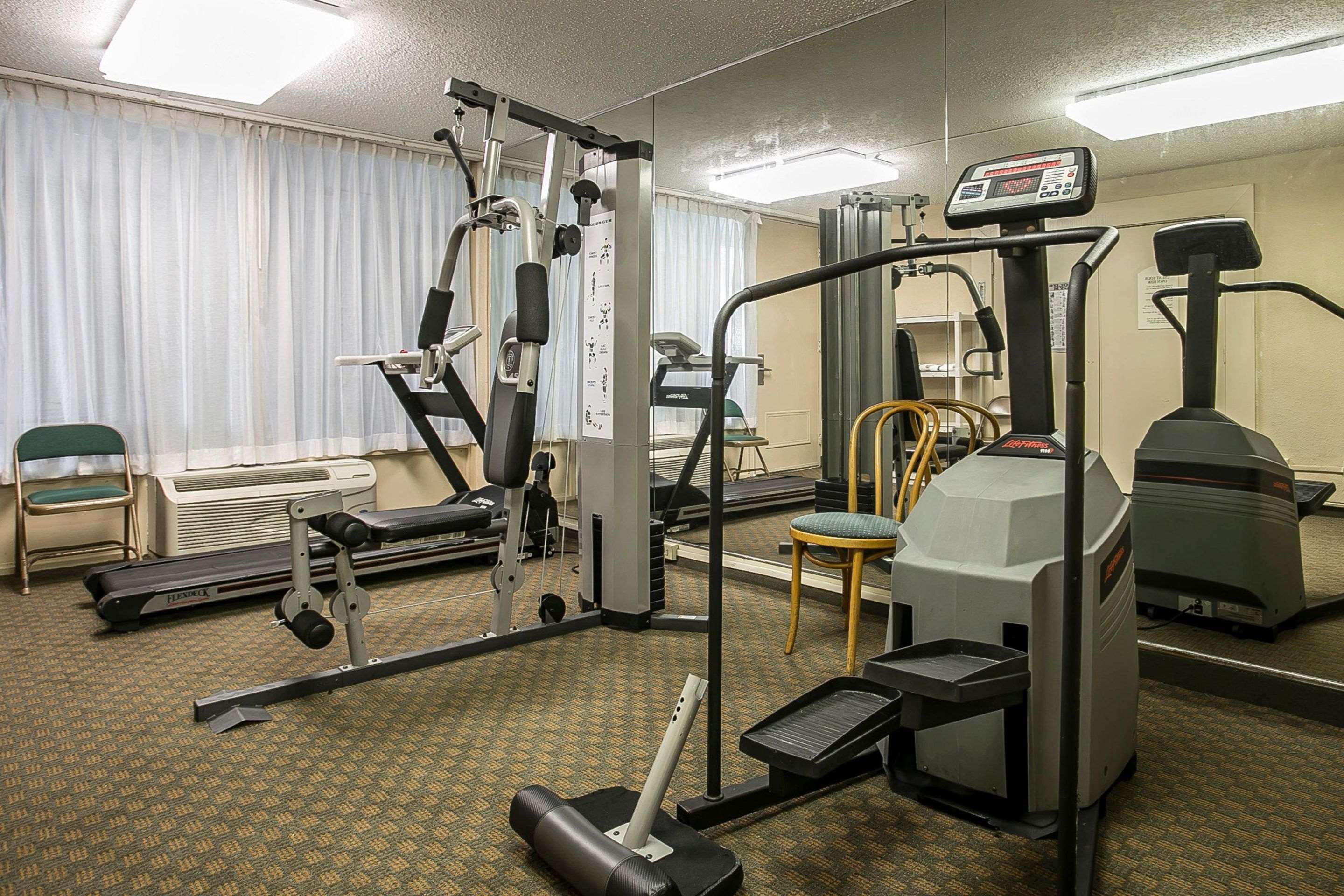 Exercise room with cardio equipment and weights | Quality Inn & Suites