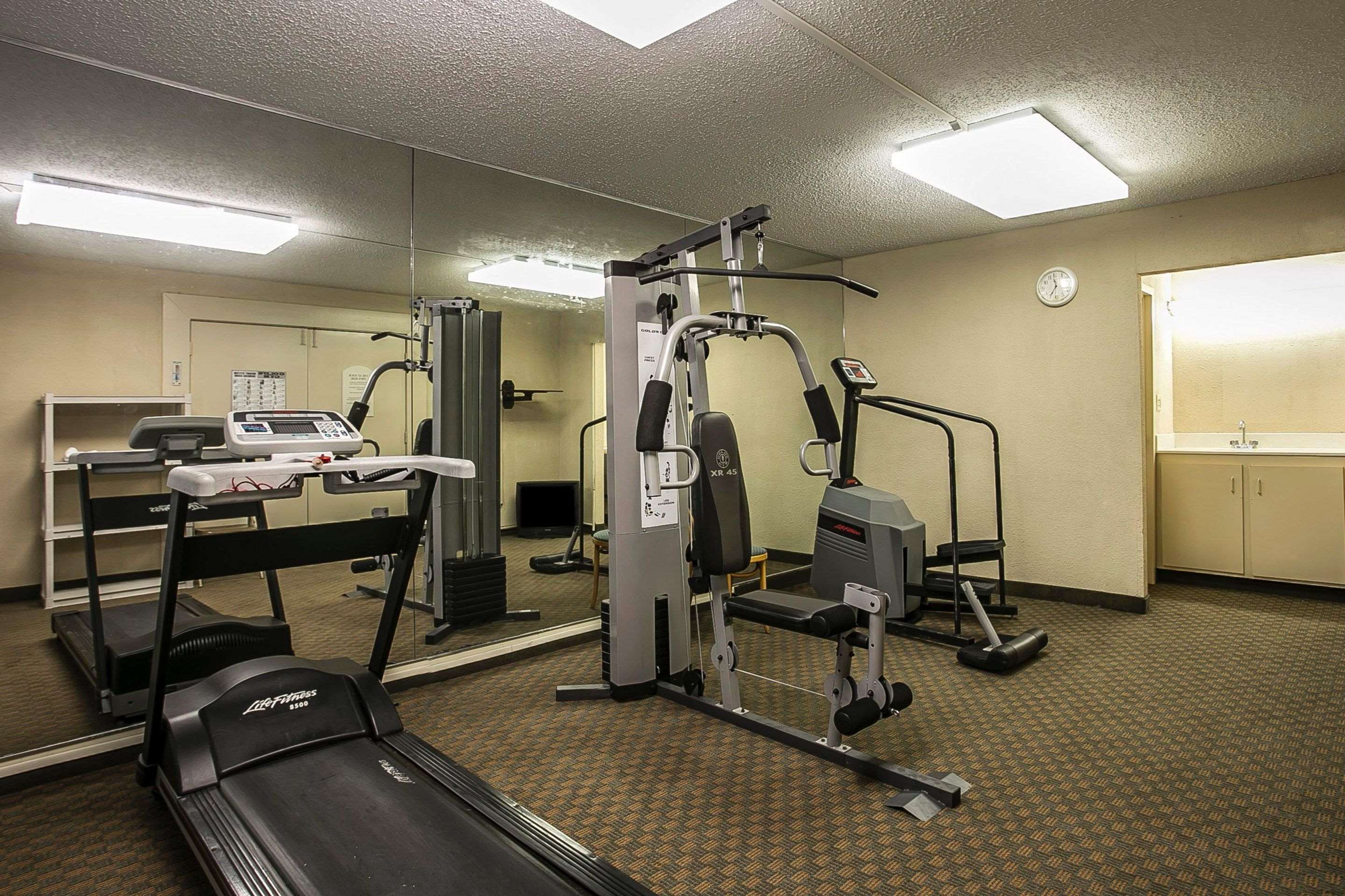 Exercise room with cardio equipment and weights | Quality Inn & Suites