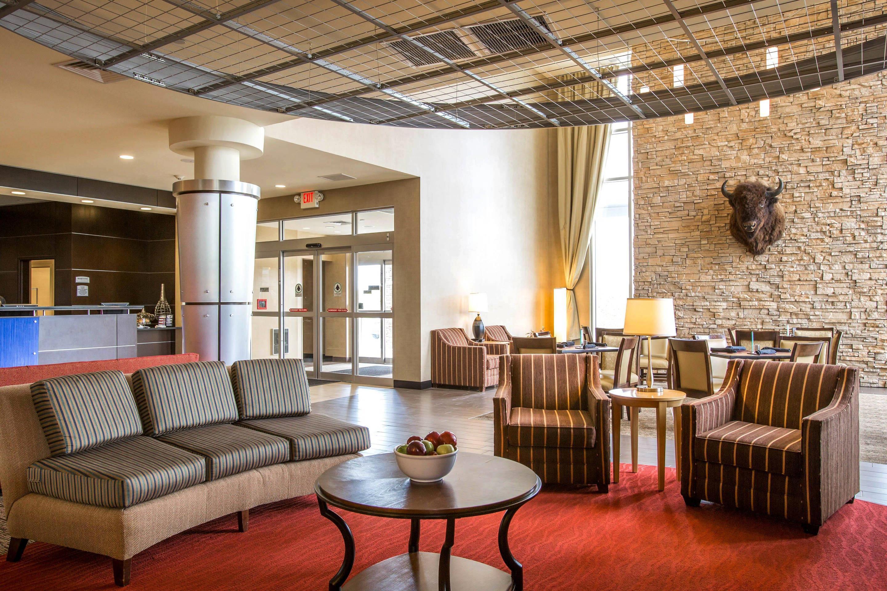 Relax in the open space lobby with club-lounge seating | Cambria Hotel Rapid City near Mount Rushmore