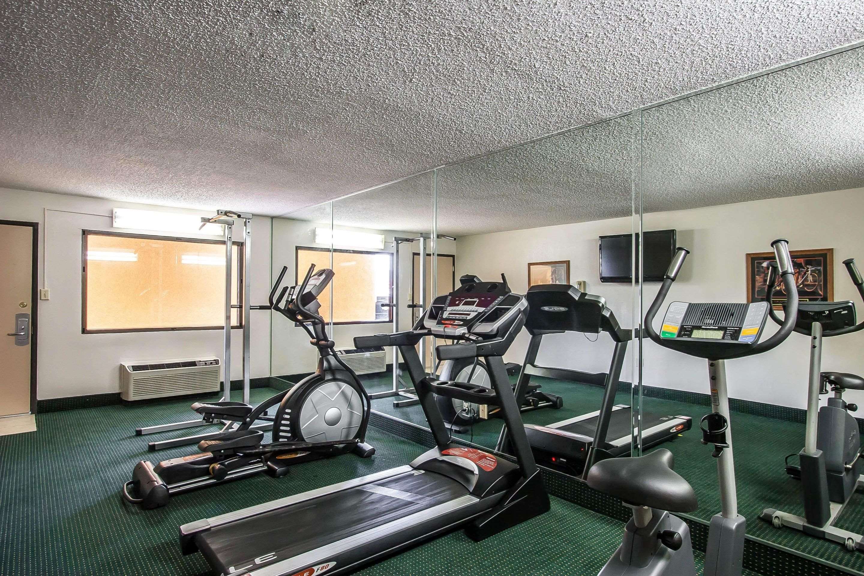 Exercise room with cardio equipment and weights | Econo Lodge Inn & Suites
