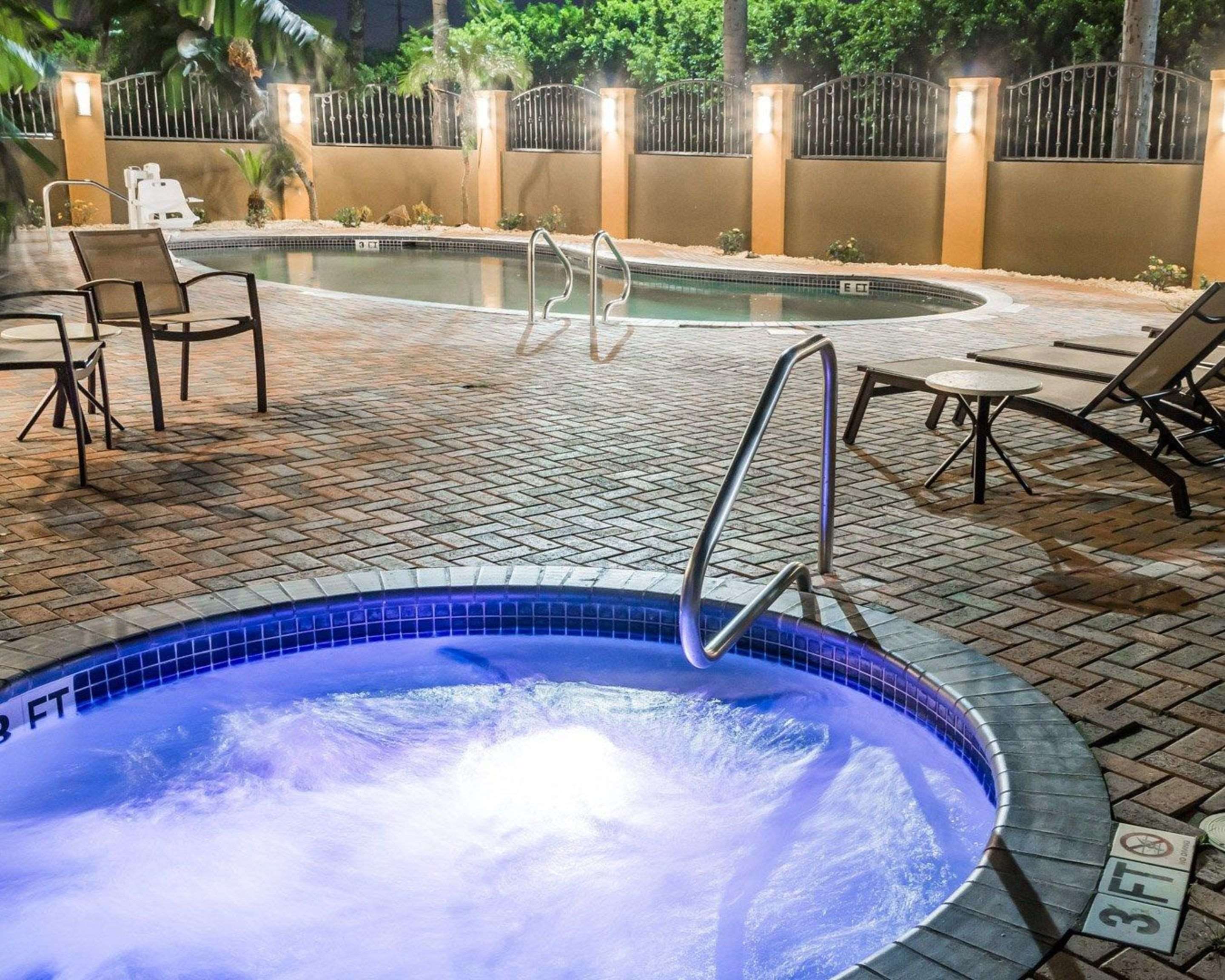 Night view of outdoor pool and hot tub | Comfort Inn & Suites
