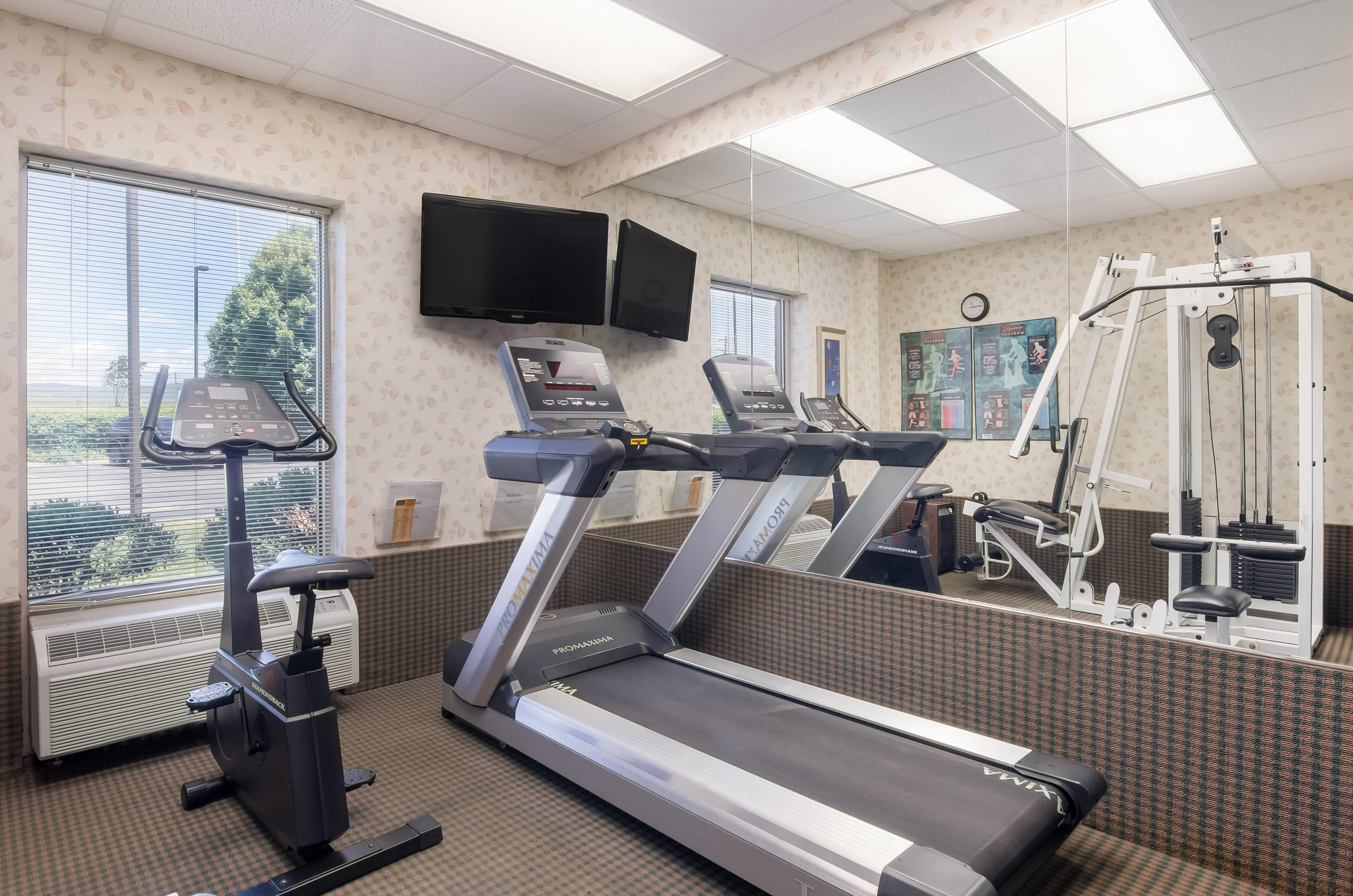 Fitness center with television | Mainstay Suites Airport