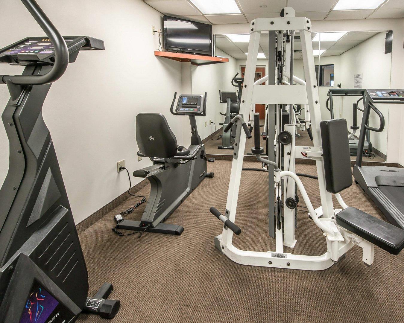 Exercise room with cardio equipment and weights | Sleep Inn & Suites