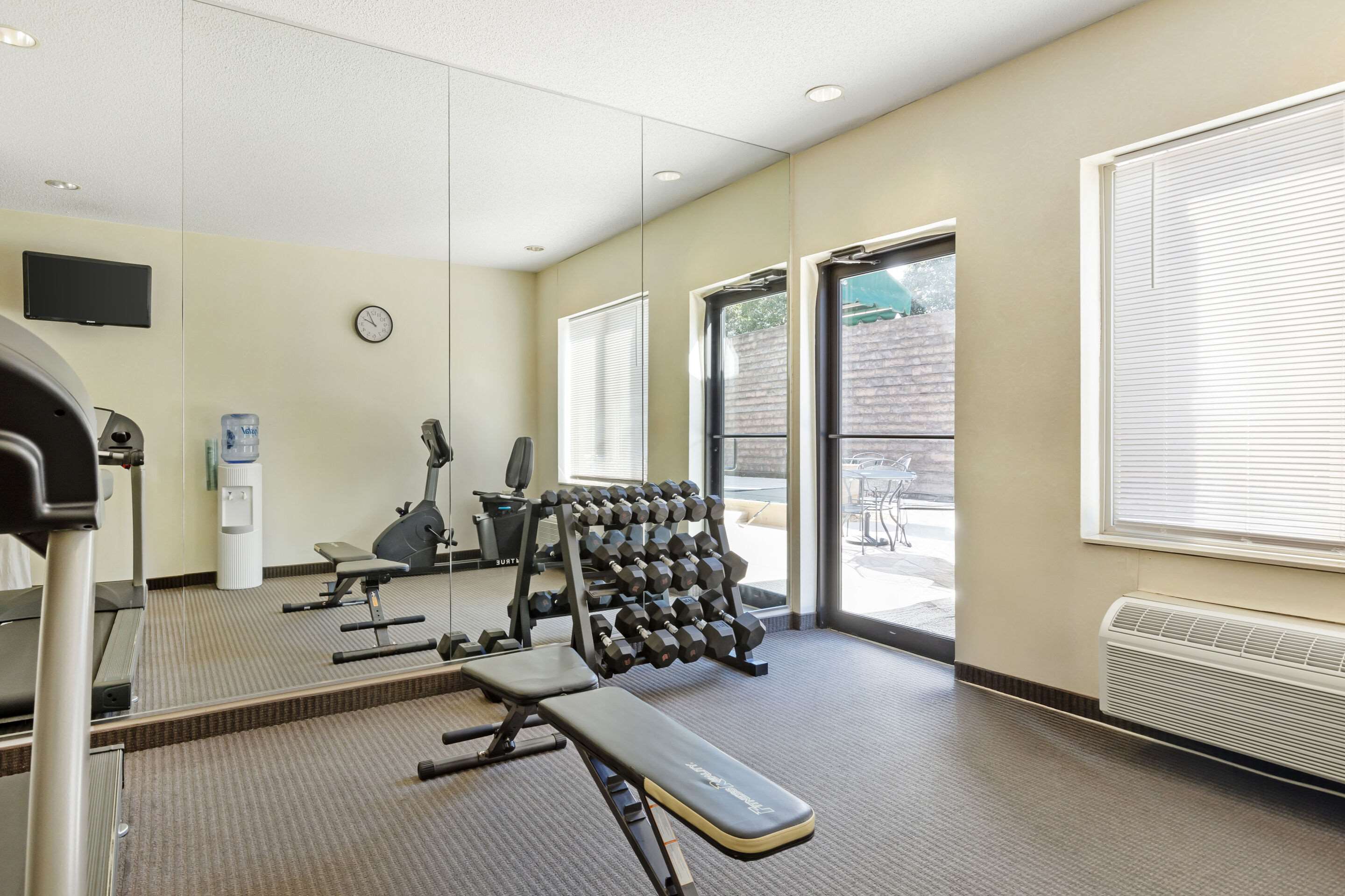 Exercise room with cardio equipment and weights