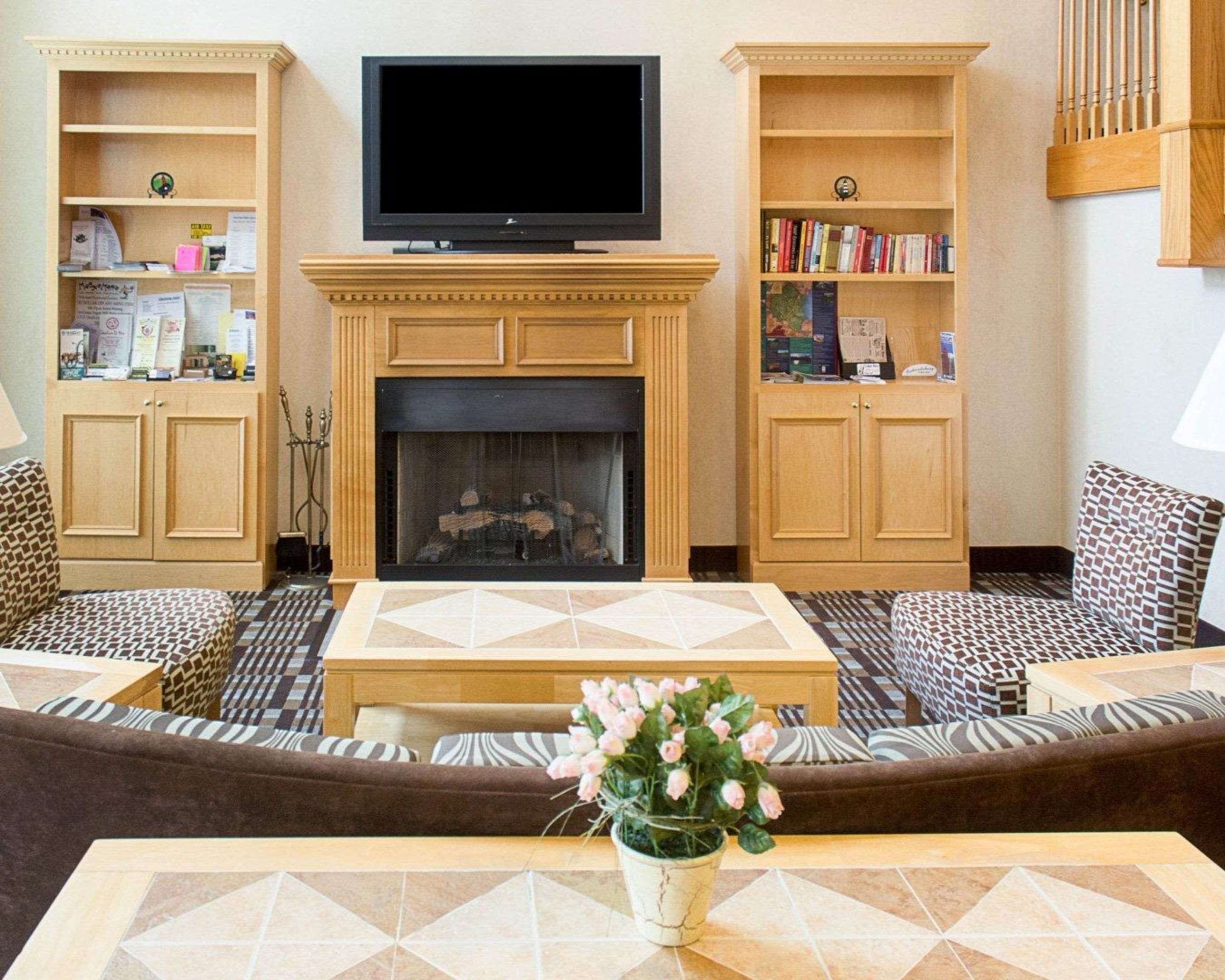 Relax by the fireplace in the lobby | Quality Inn and Suites