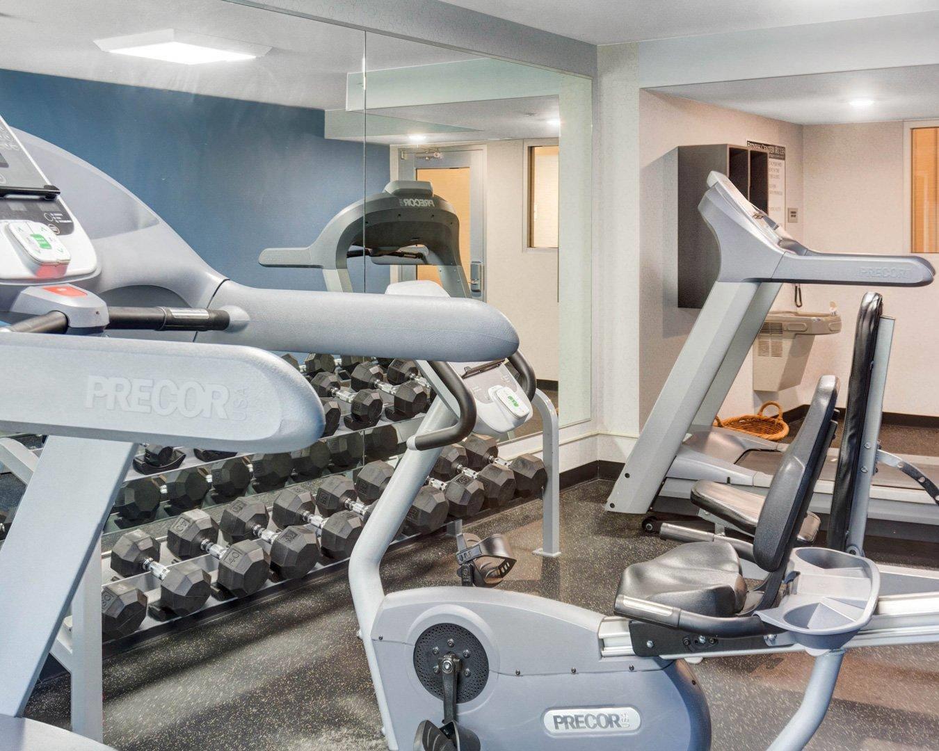 Exercise room with cardio equipment and weights