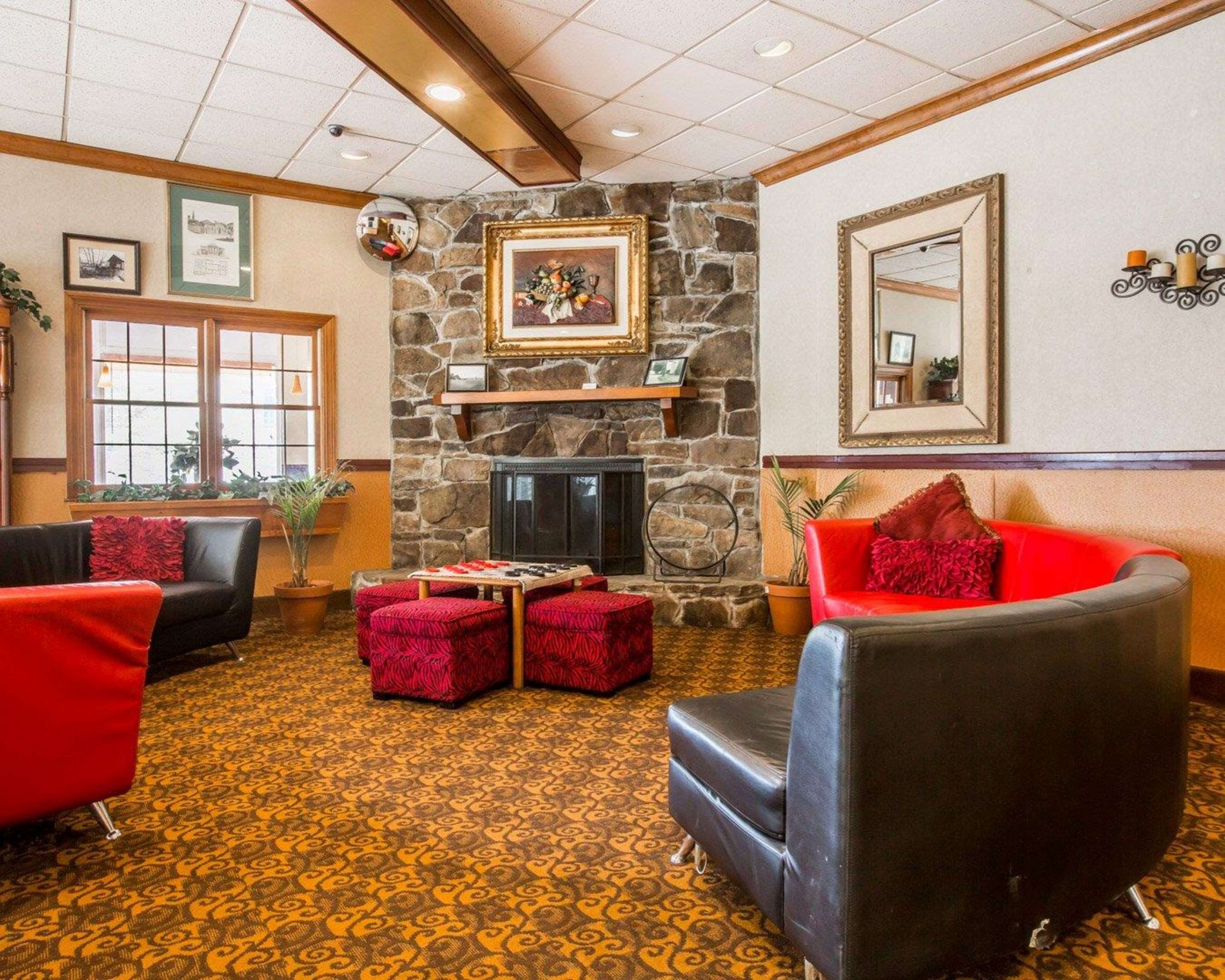 Relax by the fireplace in the lobby | Quality Inn & Conference Center