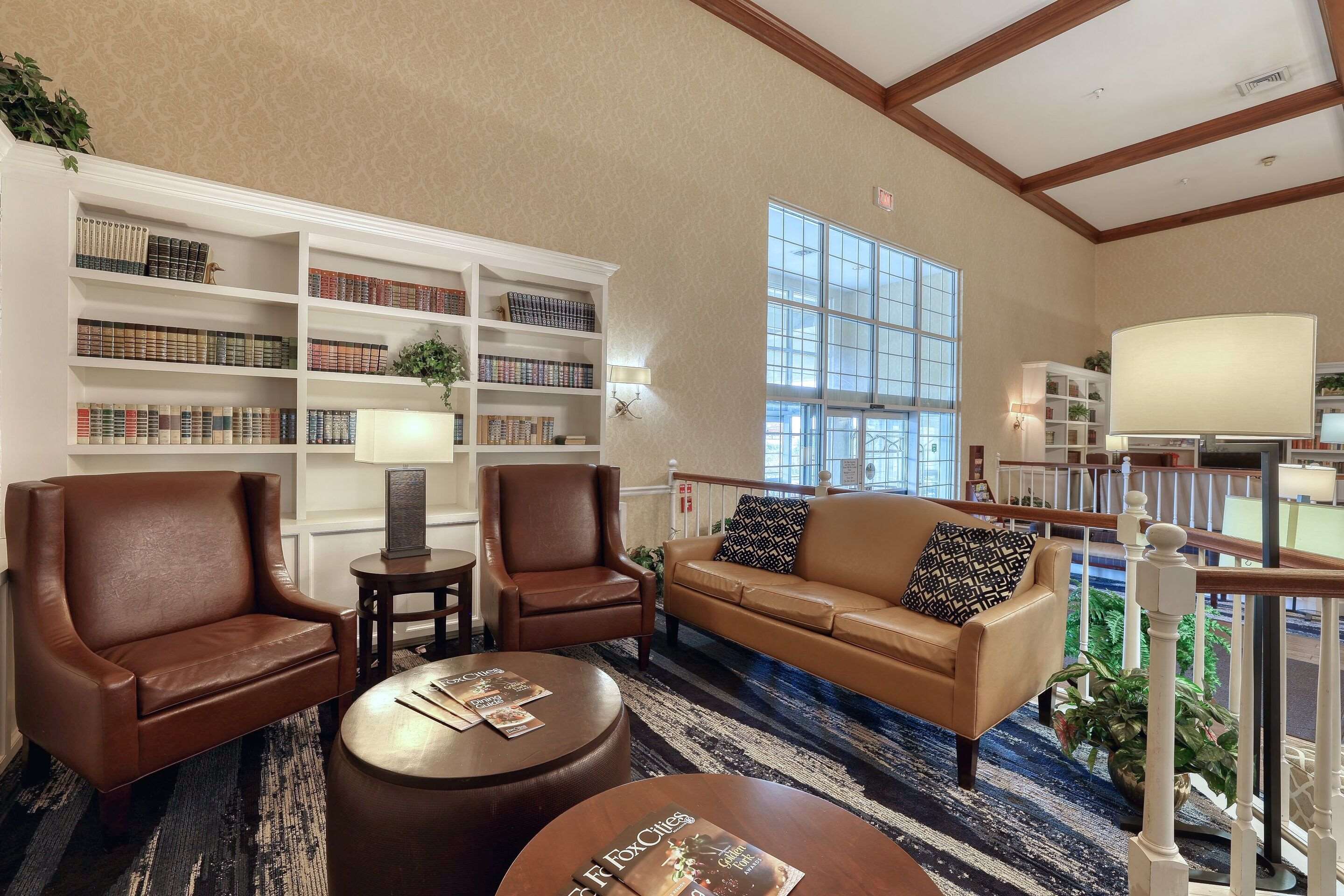 Spacious lobby with sitting area | Comfort Suites Appleton Airport