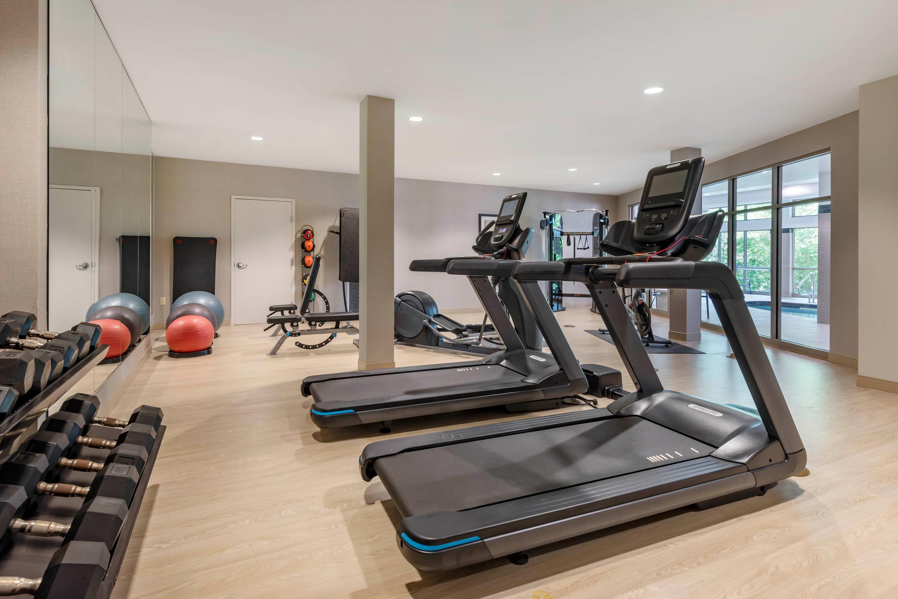 Exercise room with cardio equipment and weights | Cambria Hotel Madison East