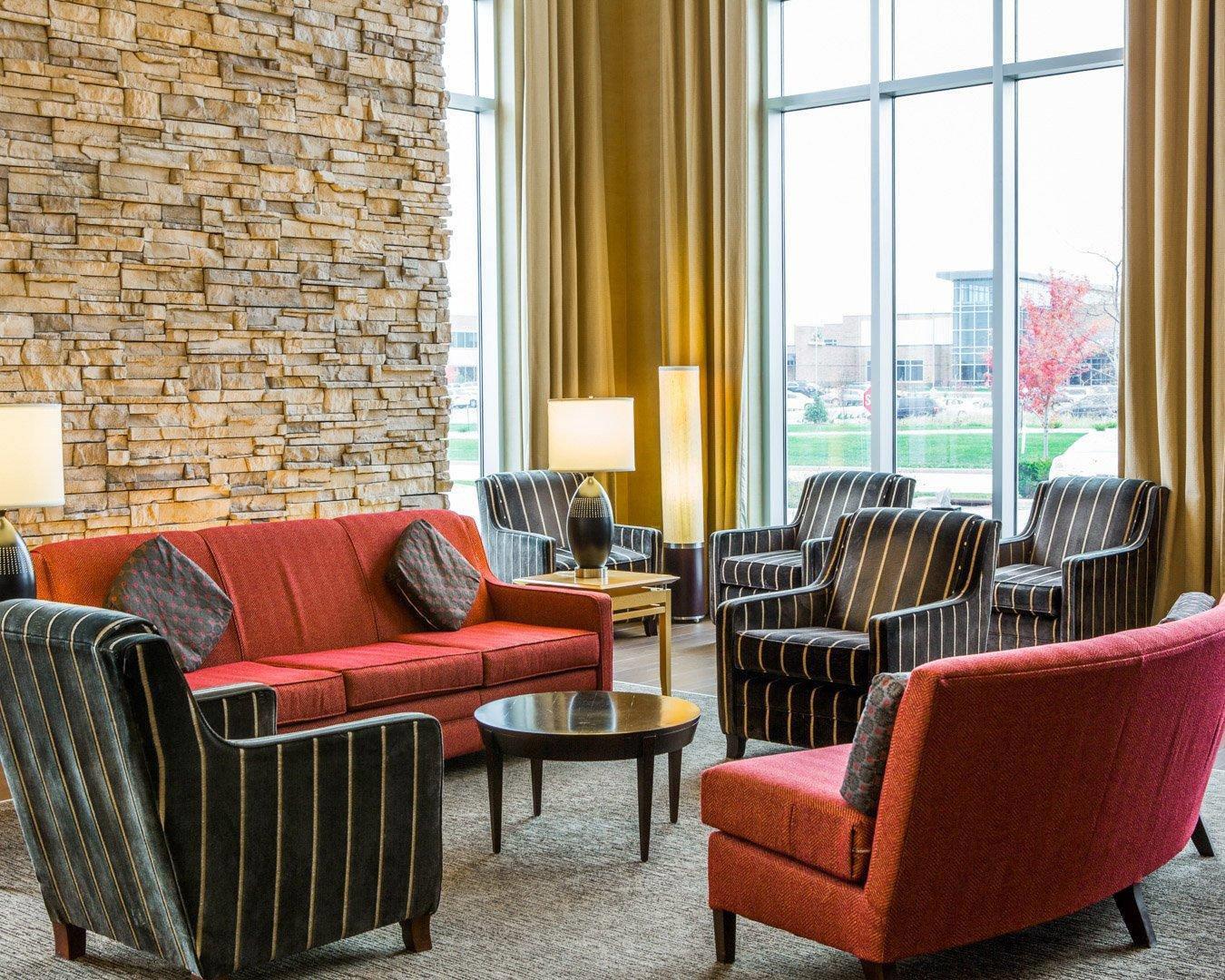 Relax in the open space lobby with club-lounge seating | Cambria Hotel Appleton