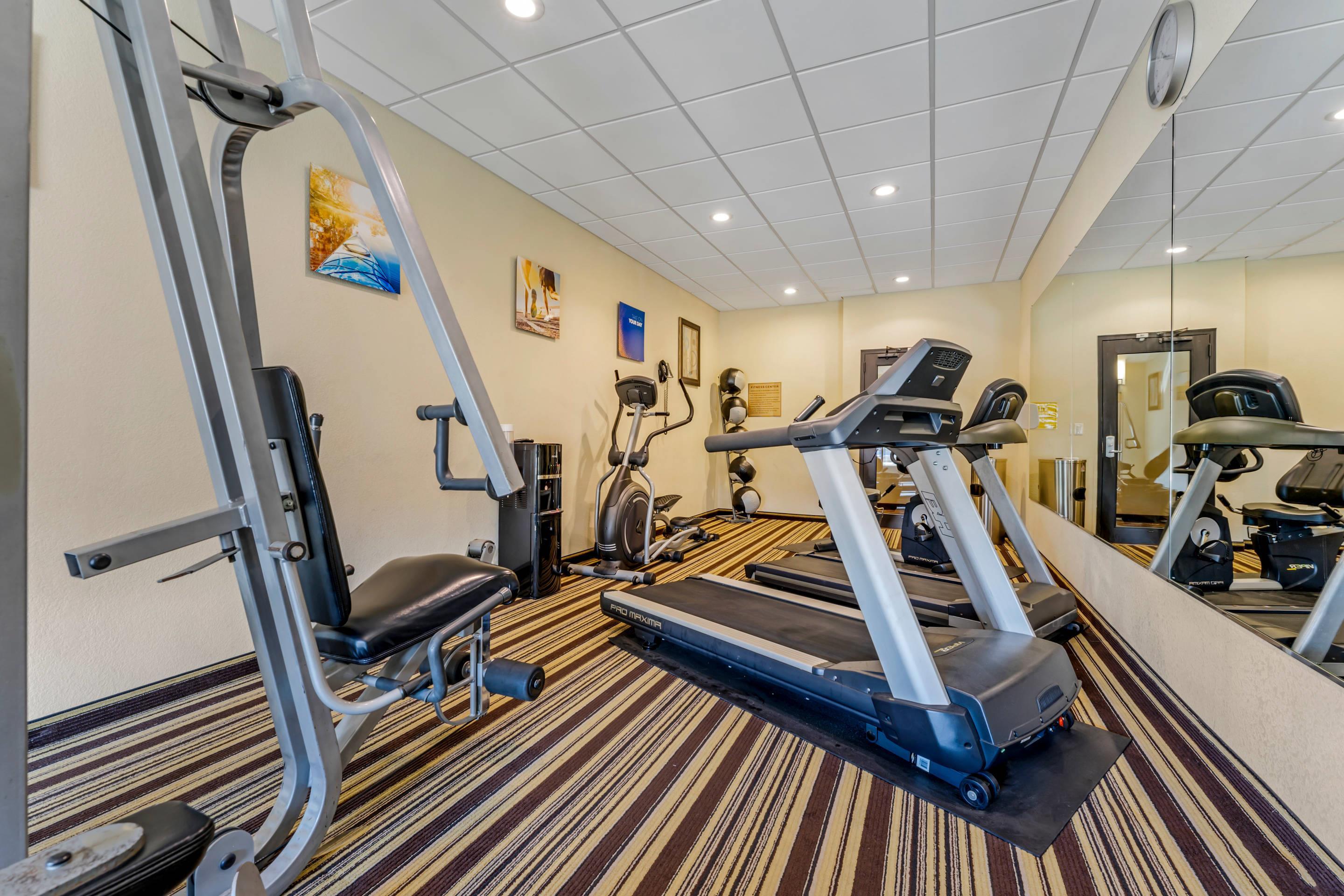 Exercise room with cardio equipment and weights | Comfort Inn & Suites