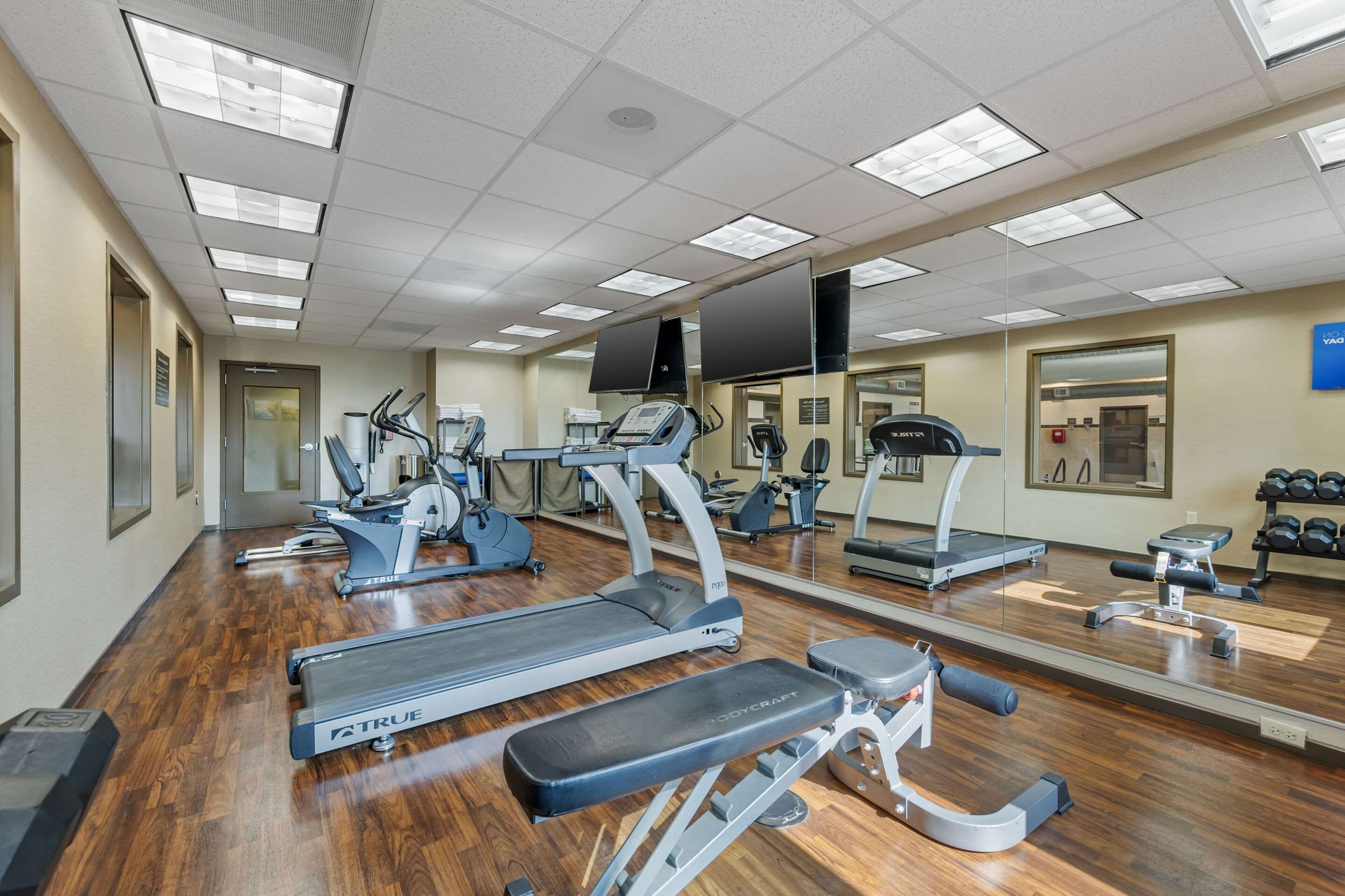 Exercise room with cardio equipment and weights | Comfort Inn & Suites