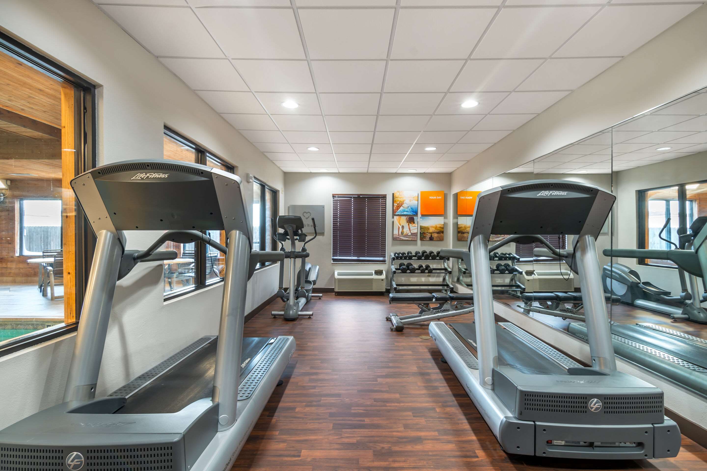 Exercise room with cardio equipment and weights | Comfort Suites Manhattan