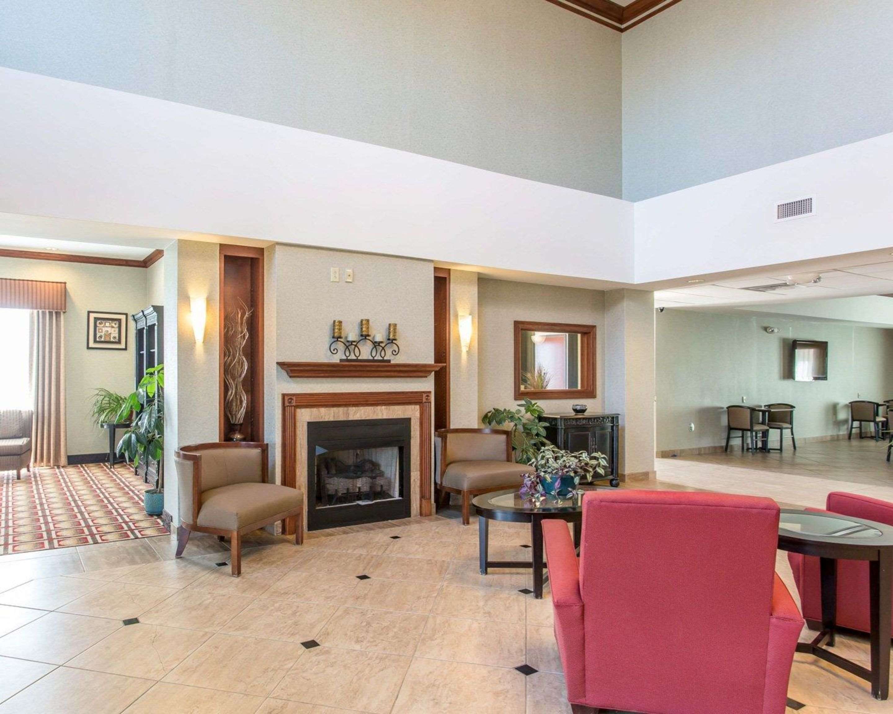 Relax by the fireplace in the lobby | Comfort Inn And Suites