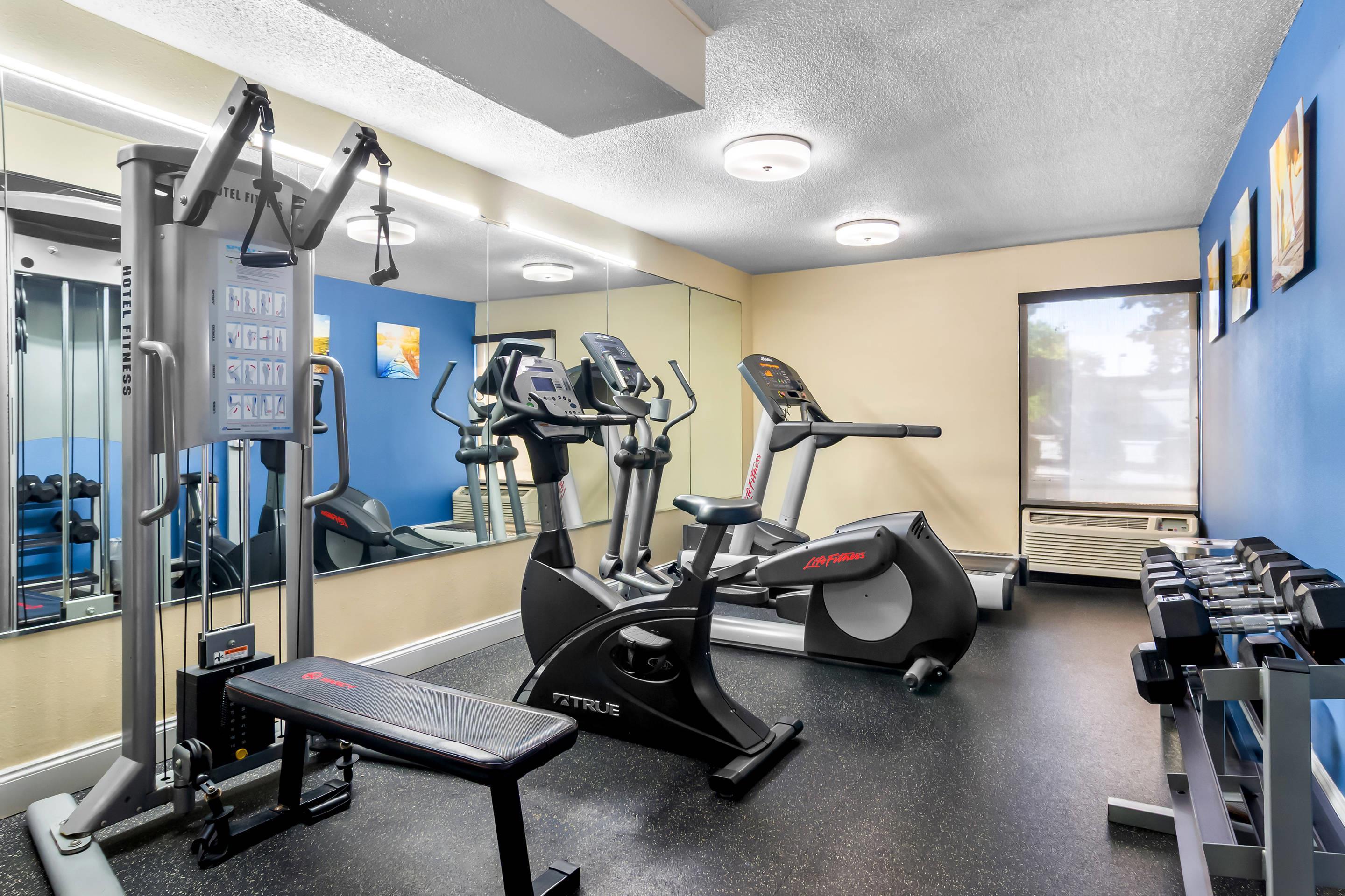 Exercise room with cardio equipment and weights
