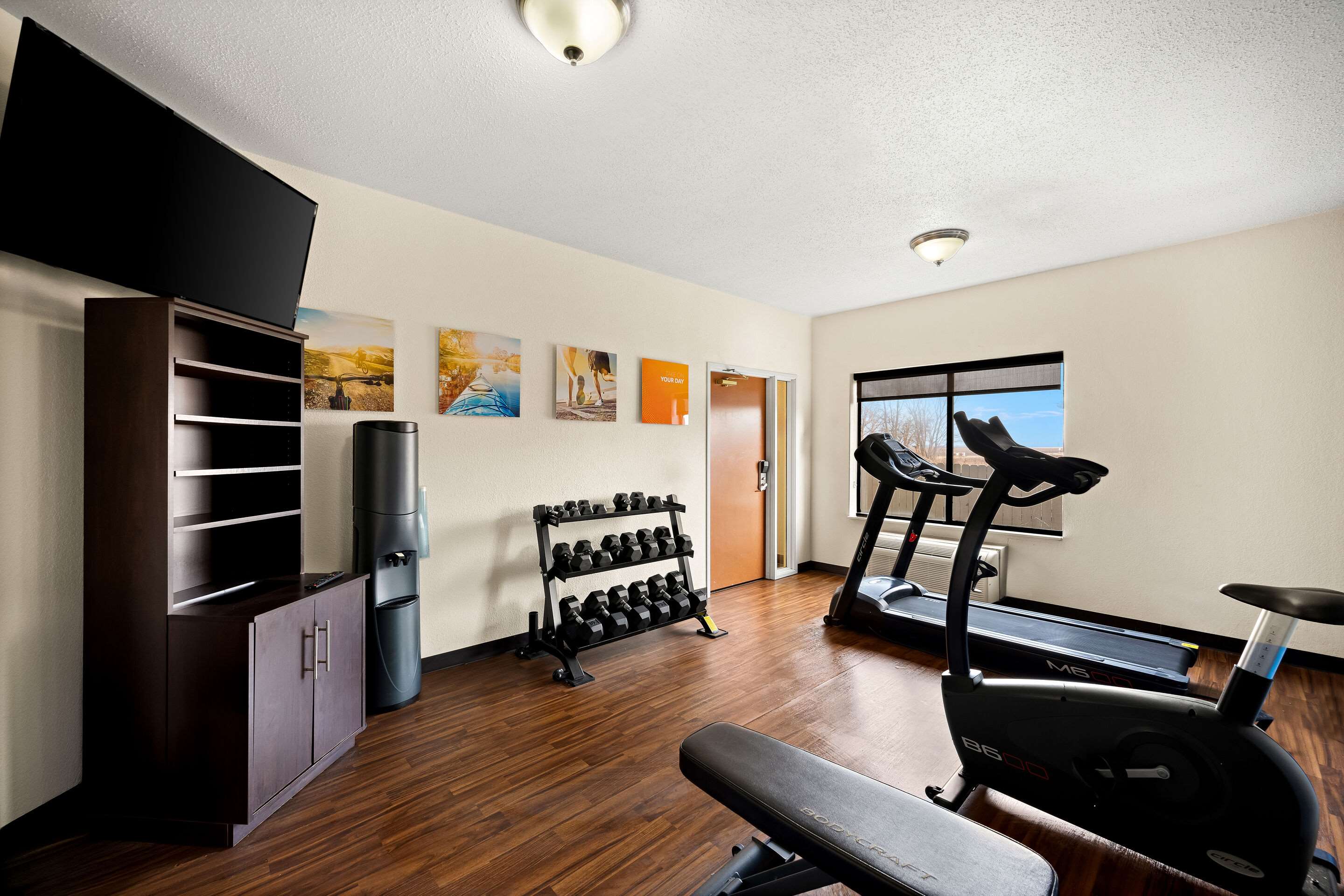 Exercise room with cardio equipment and weights