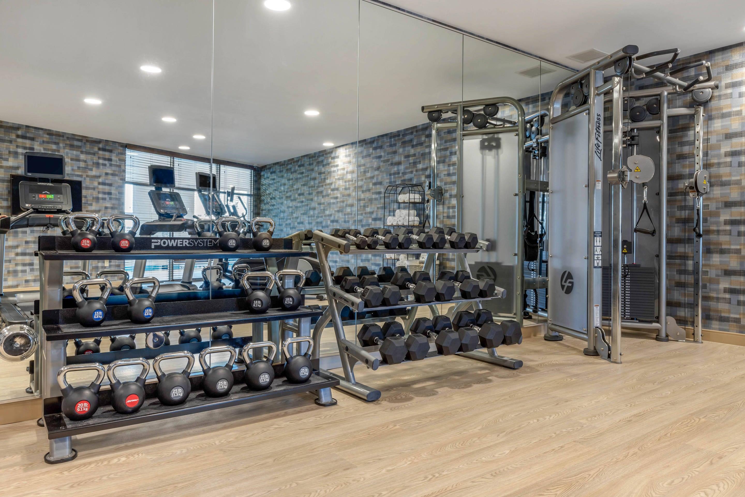 Exercise room with cardio equipment and weights | Cambria Hotel West Orange