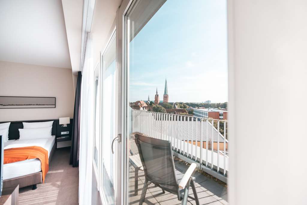 ATLANTIC Hotel Luebeck-guestroom-Guest Room,Balcony,Guest Room Amenity,Architecture,On-Site,View from room,Exterior View of Building.jpg