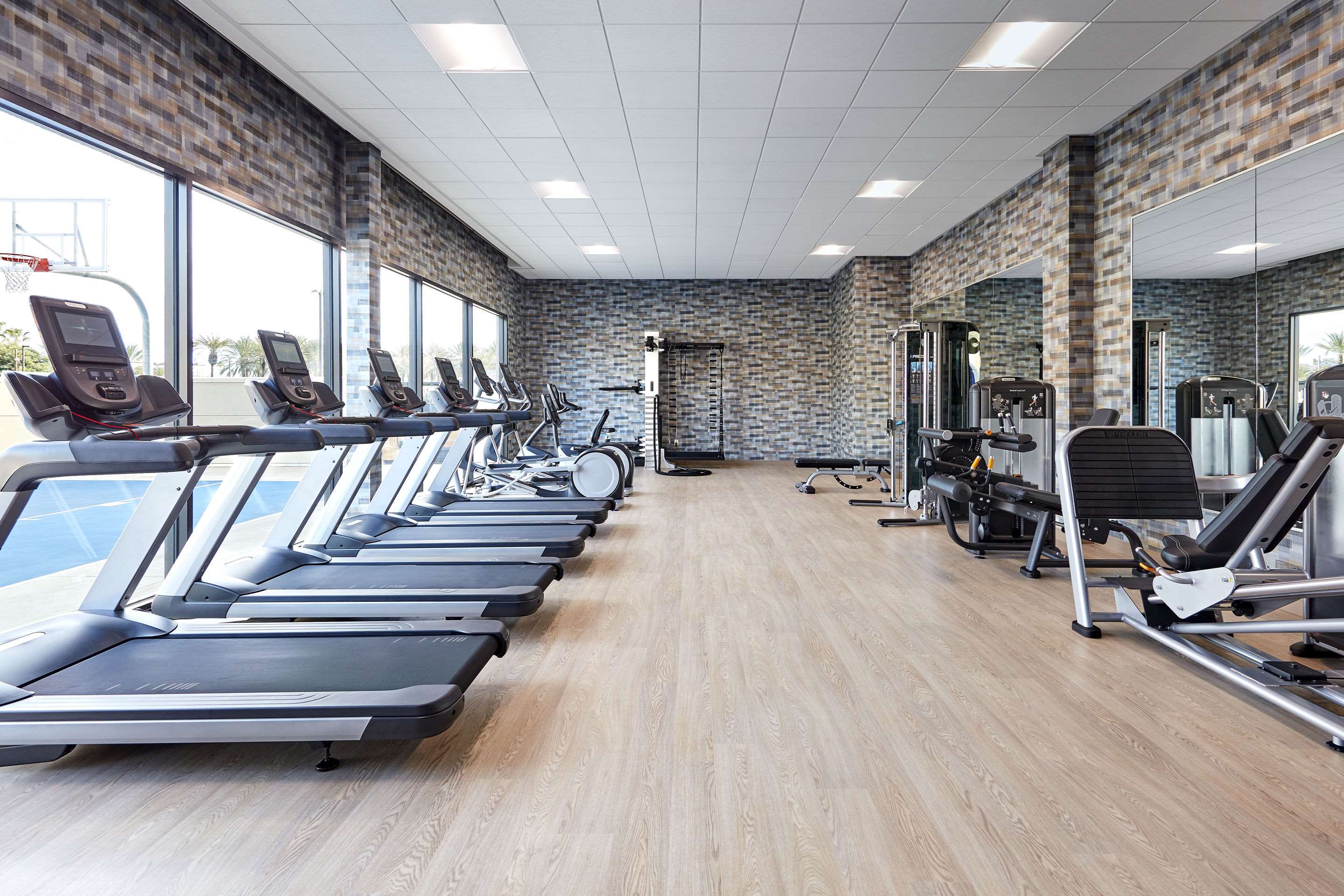 Exercise room with cardio equipment and weights | Cambria Hotel Anaheim Resort Area