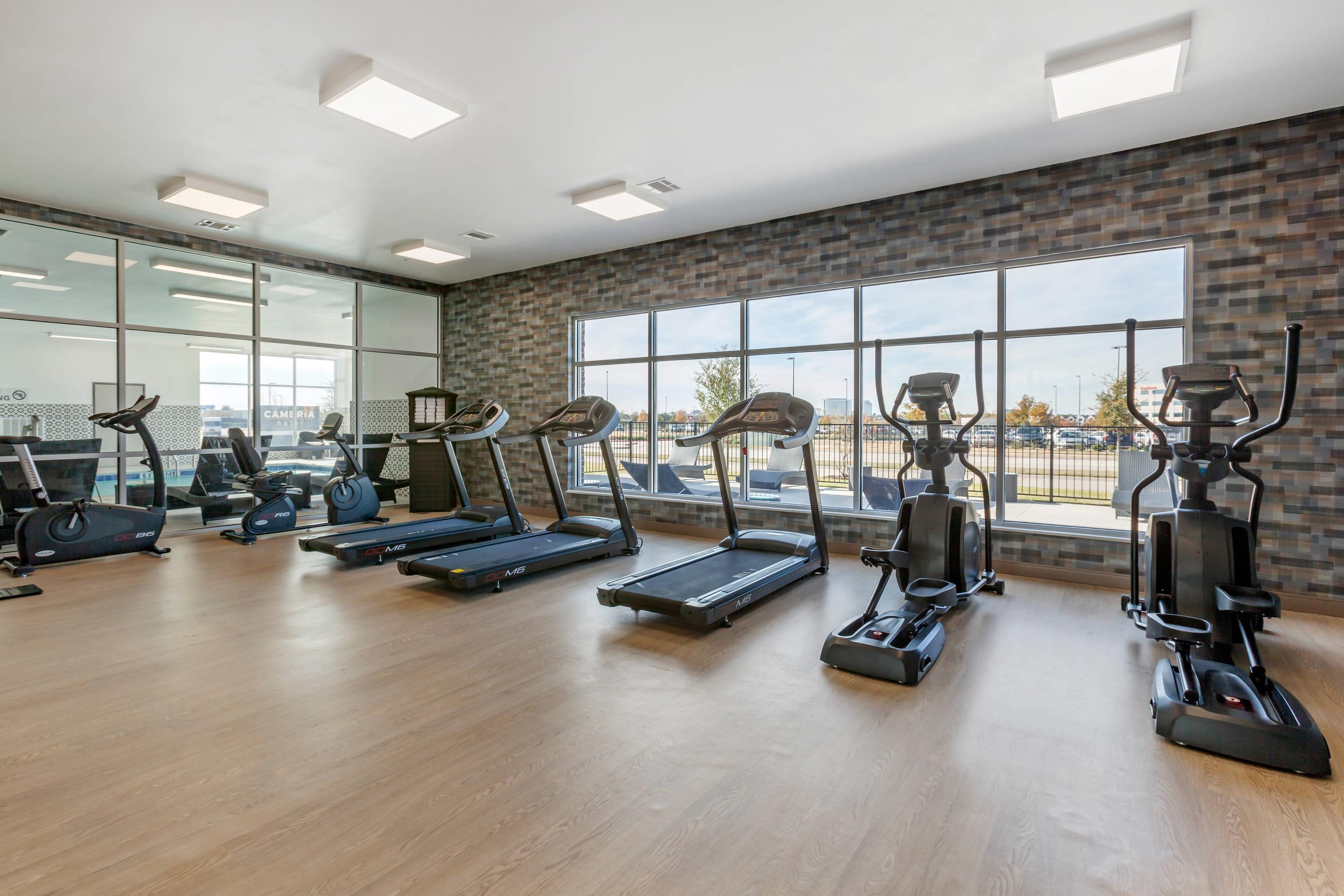 Exercise room with cardio equipment and weights | Cambria Hotel Richardson - Dallas