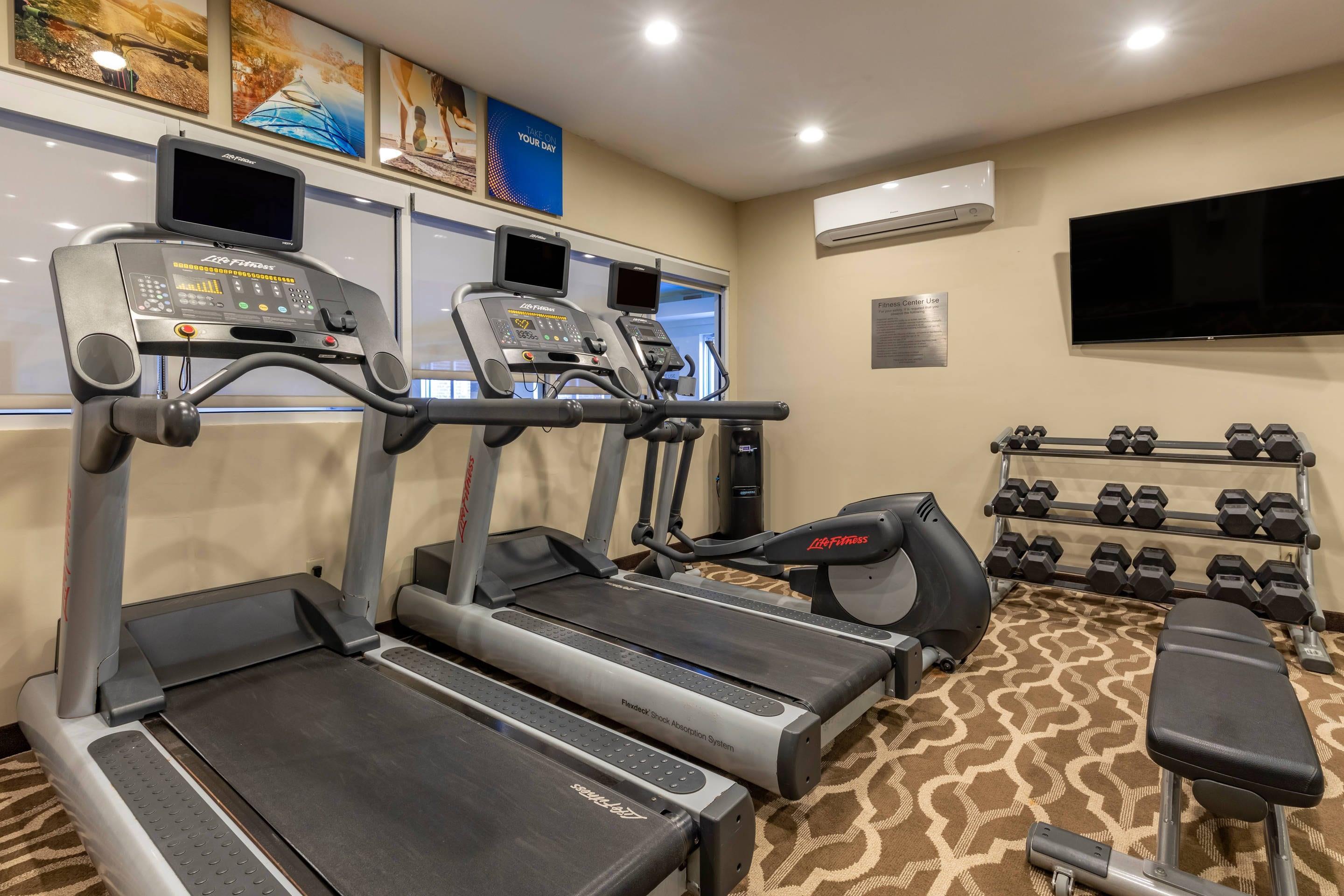Exercise room with cardio equipment and weights | Comfort Inn & Suites North Dallas - Addison
