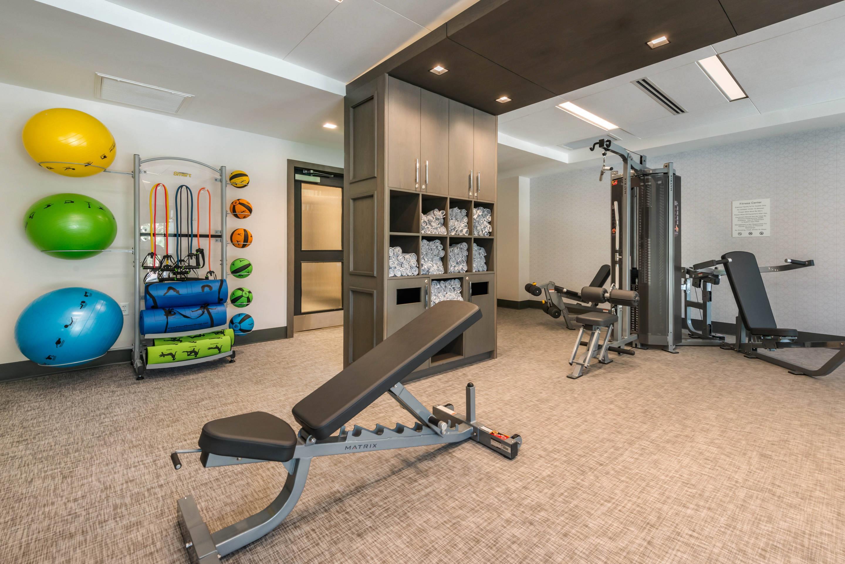 Exercise room with cardio equipment and weights | Cambria Hotel Houston Downtown Convention Center