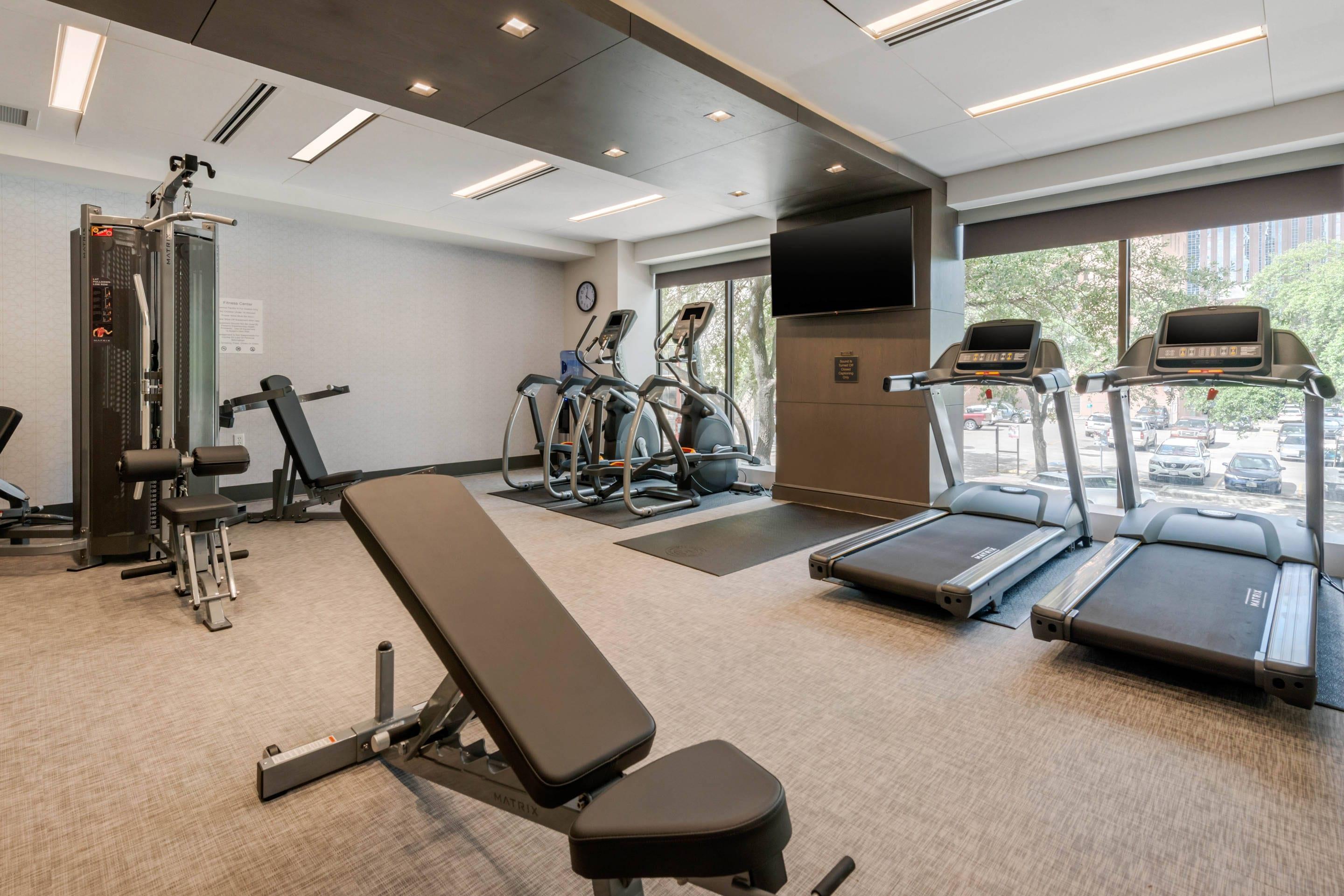 Exercise room with cardio equipment and weights | Cambria Hotel Houston Downtown Convention Center