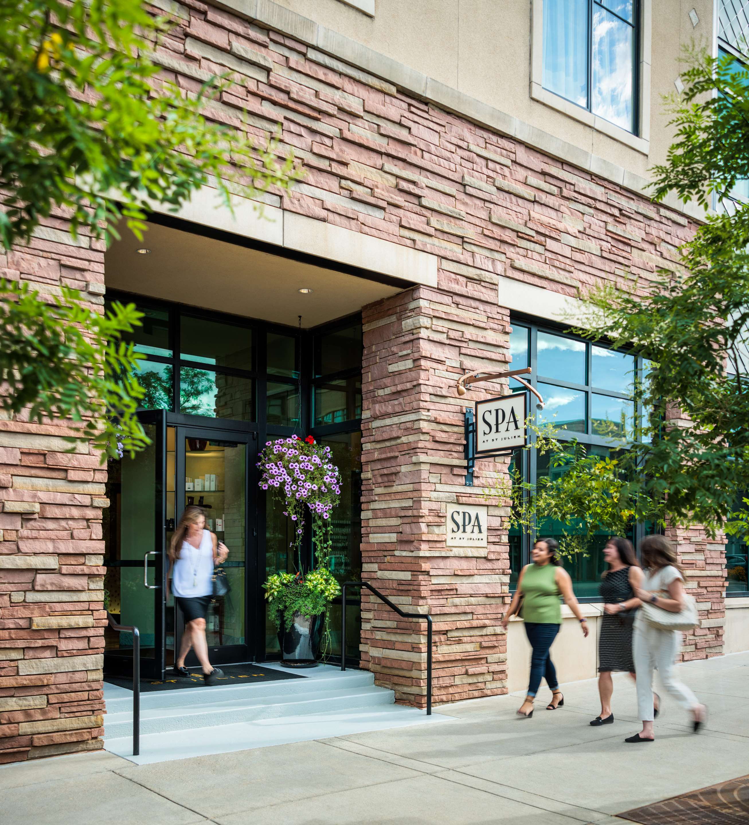 Spa at St Julien entryway with happy patrons | St Julien Hotel and Spa