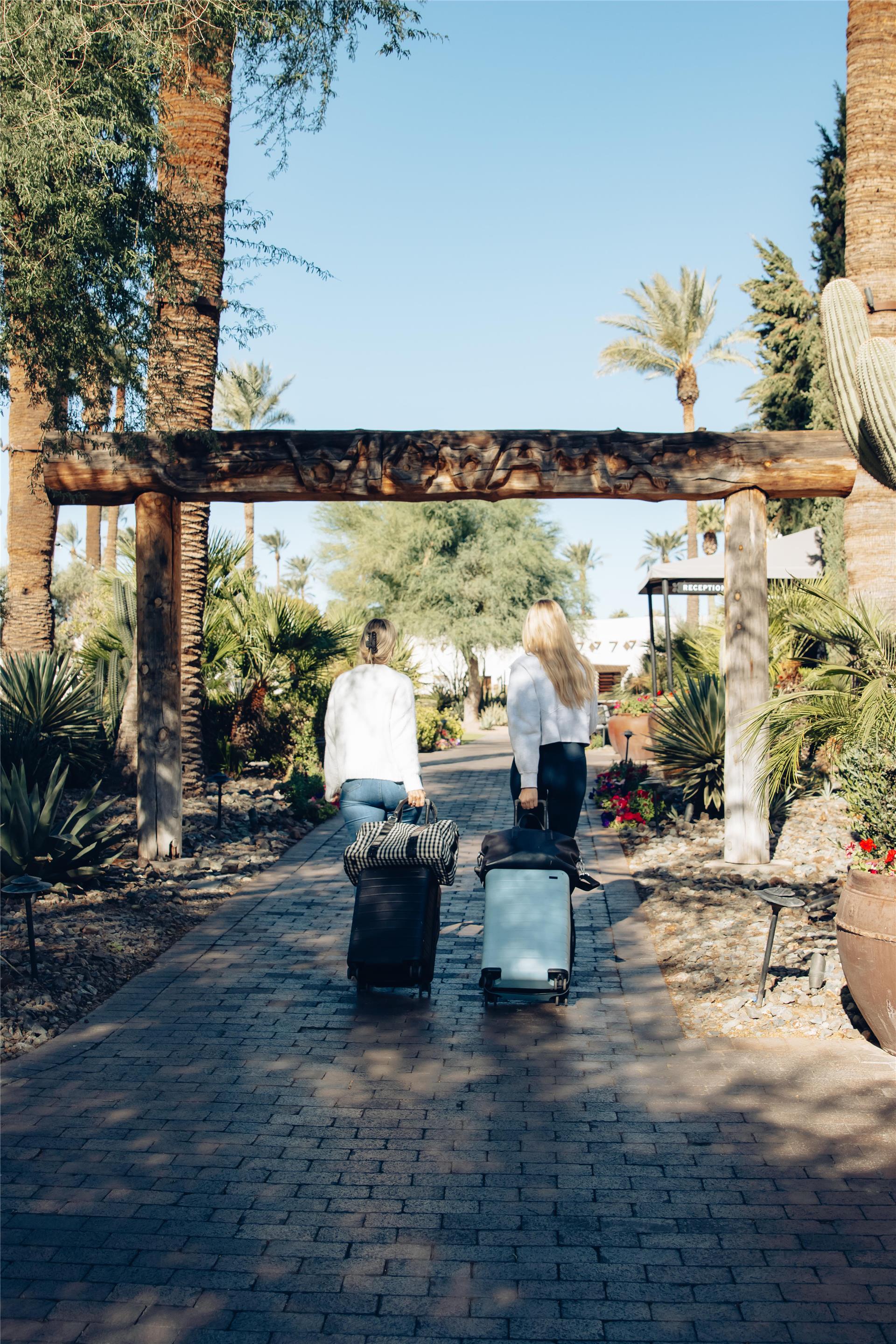 Two Women with Suitcases Checking In | The Wigwam