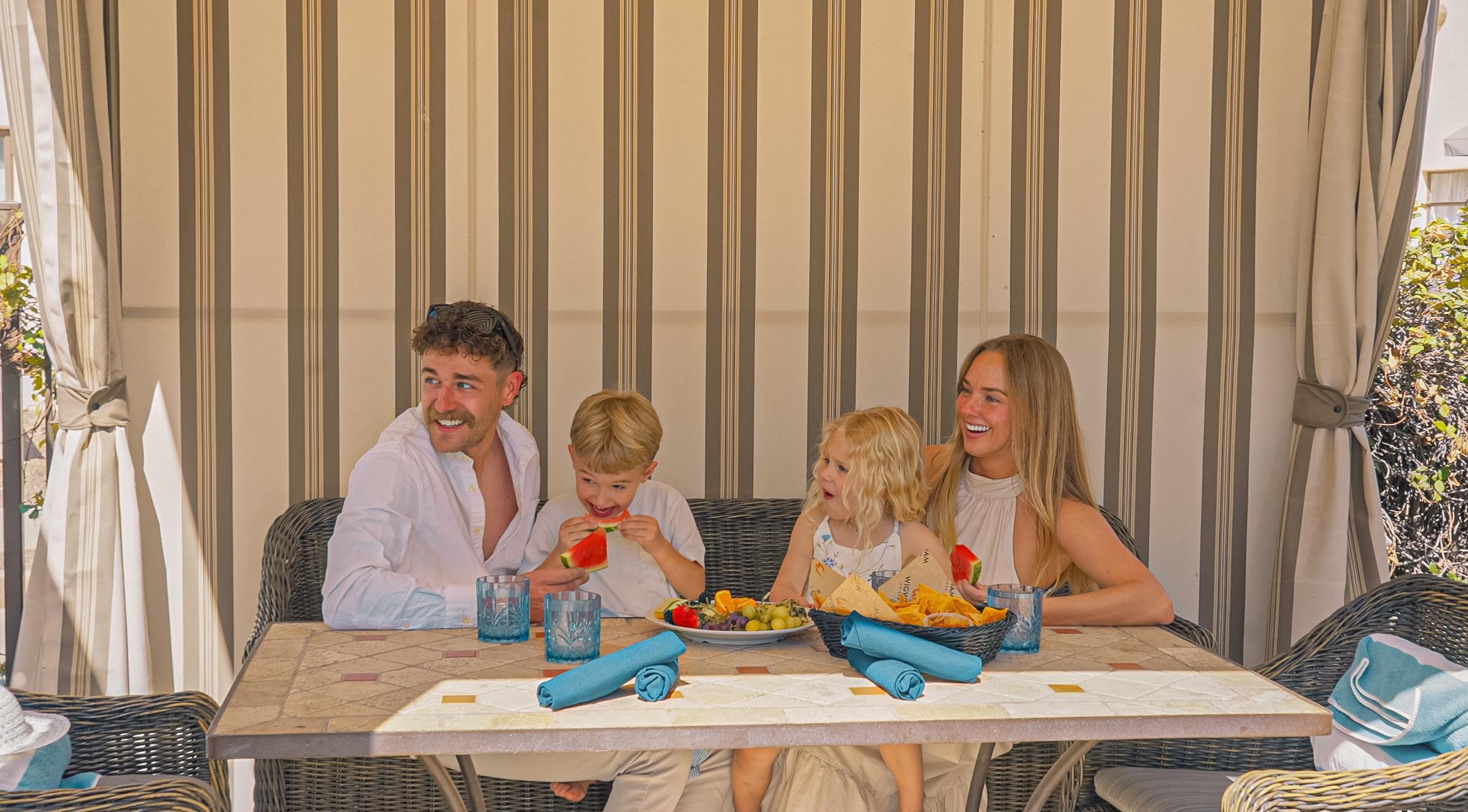 Family relaxing in a cabana at Tower Pool