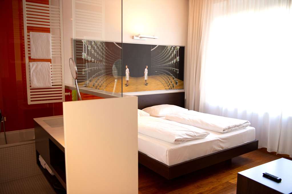 ARTE HOTEL LINZ-guestroom-Guest Room,Bathroom,Sink,Bed,Bedding,Indoor/Interior,On-Site,People,Décor detail,Summer,View from room.jpg