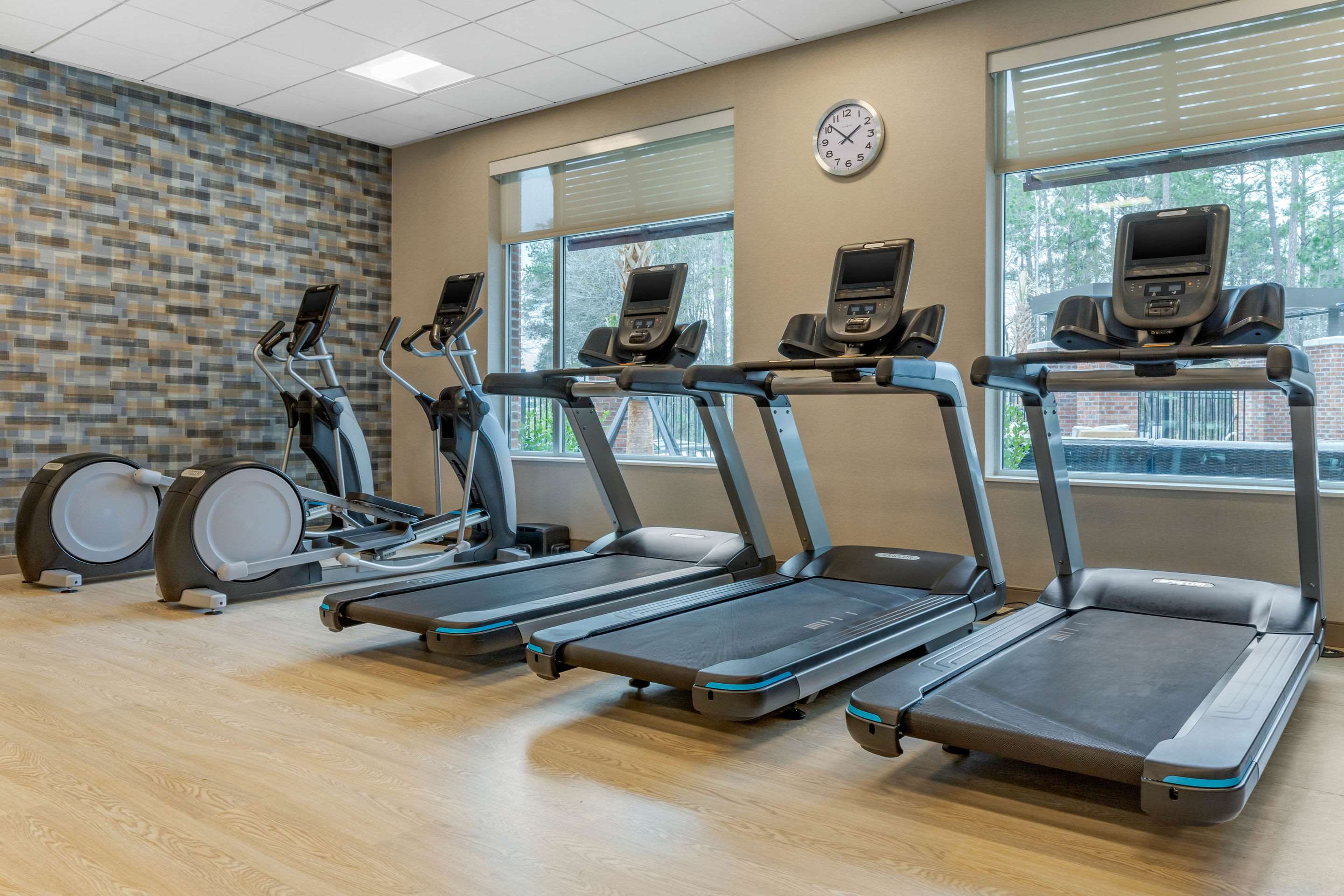 Exercise room with cardio equipment and weights | DoubleTree by Hilton Summerville Nexton
