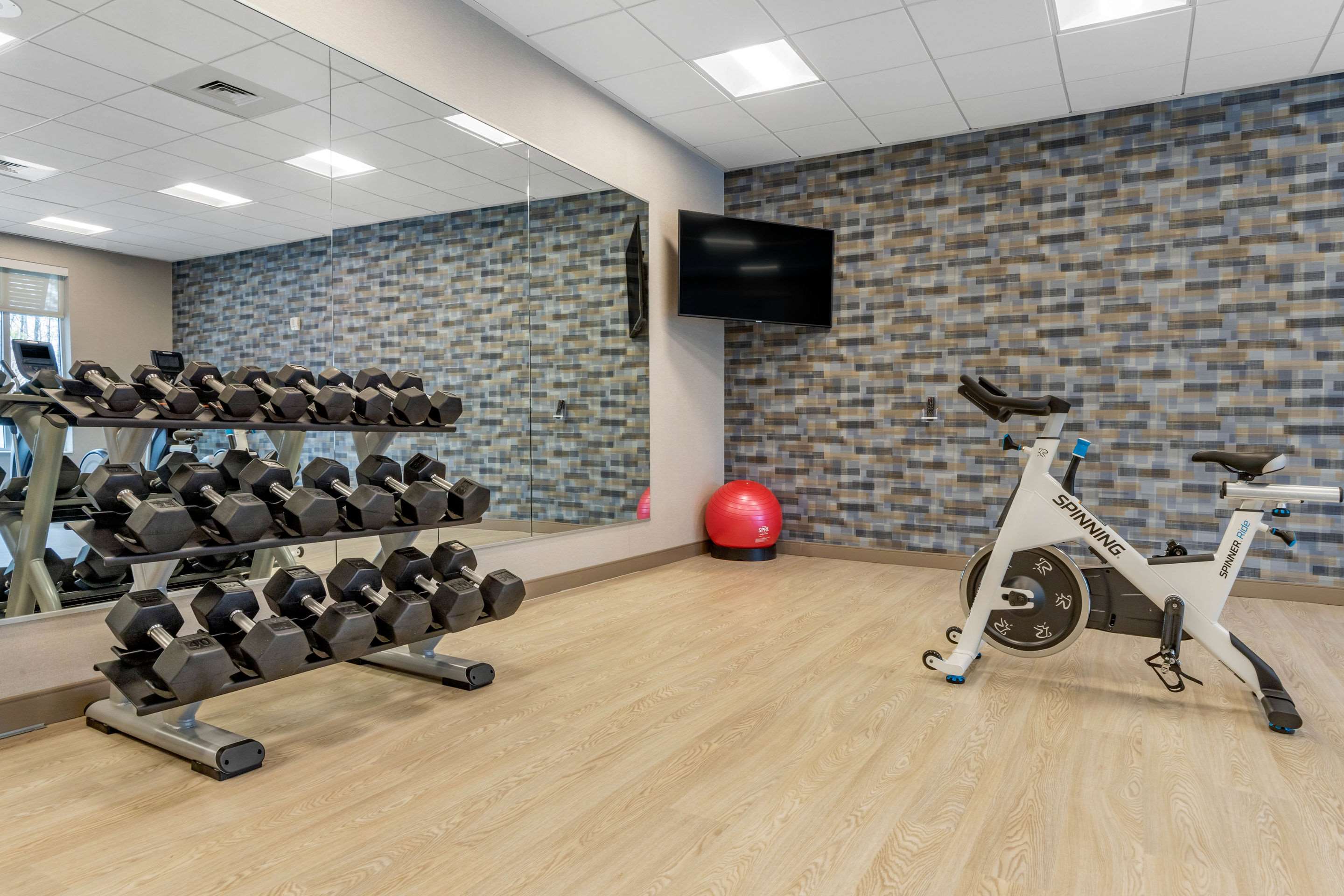 Exercise room with cardio equipment and weights | DoubleTree by Hilton Summerville Nexton