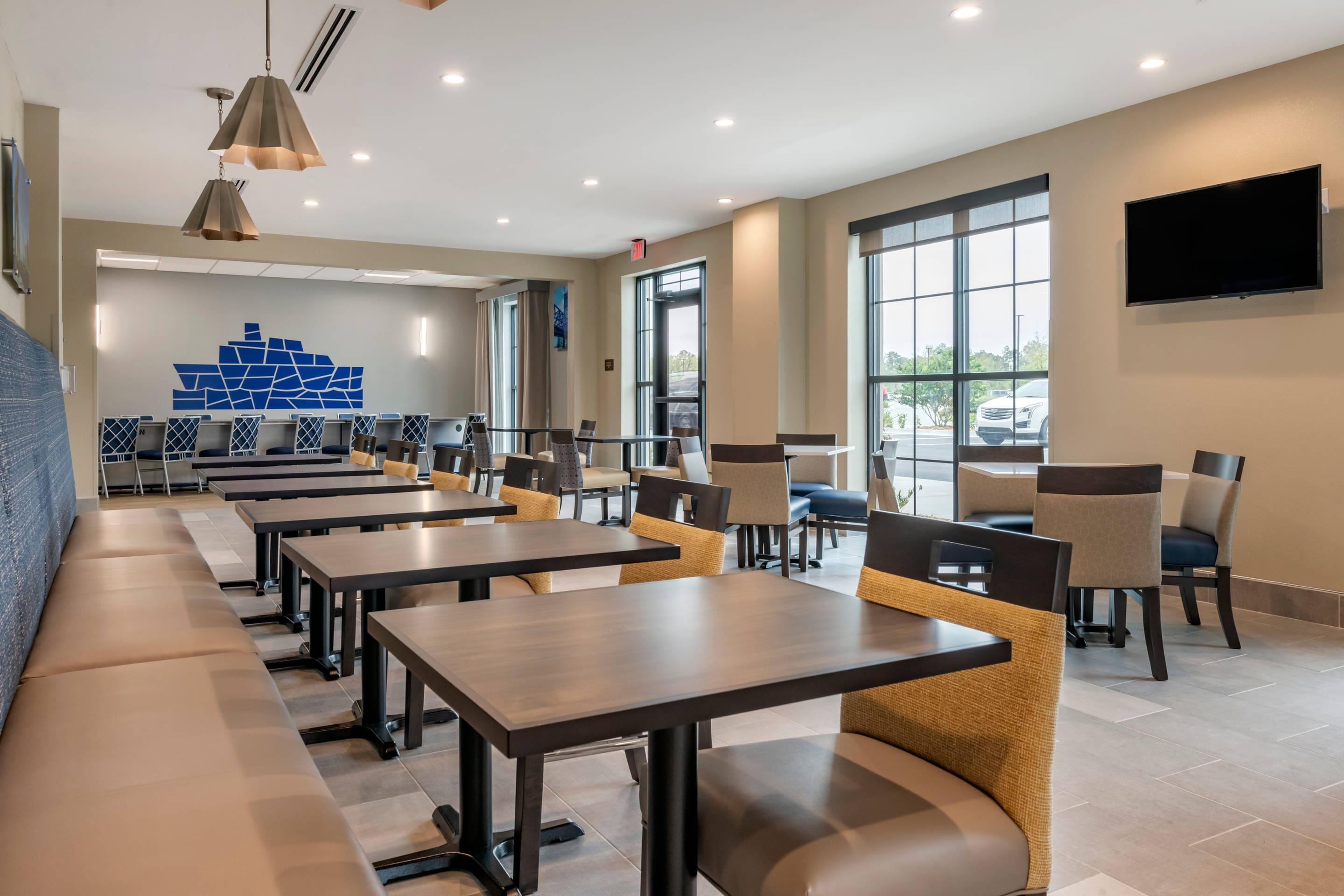Enjoy breakfast in this seating area | Comfort Inn & Suites Jacksonville - Orange Park Near Naval Air Station