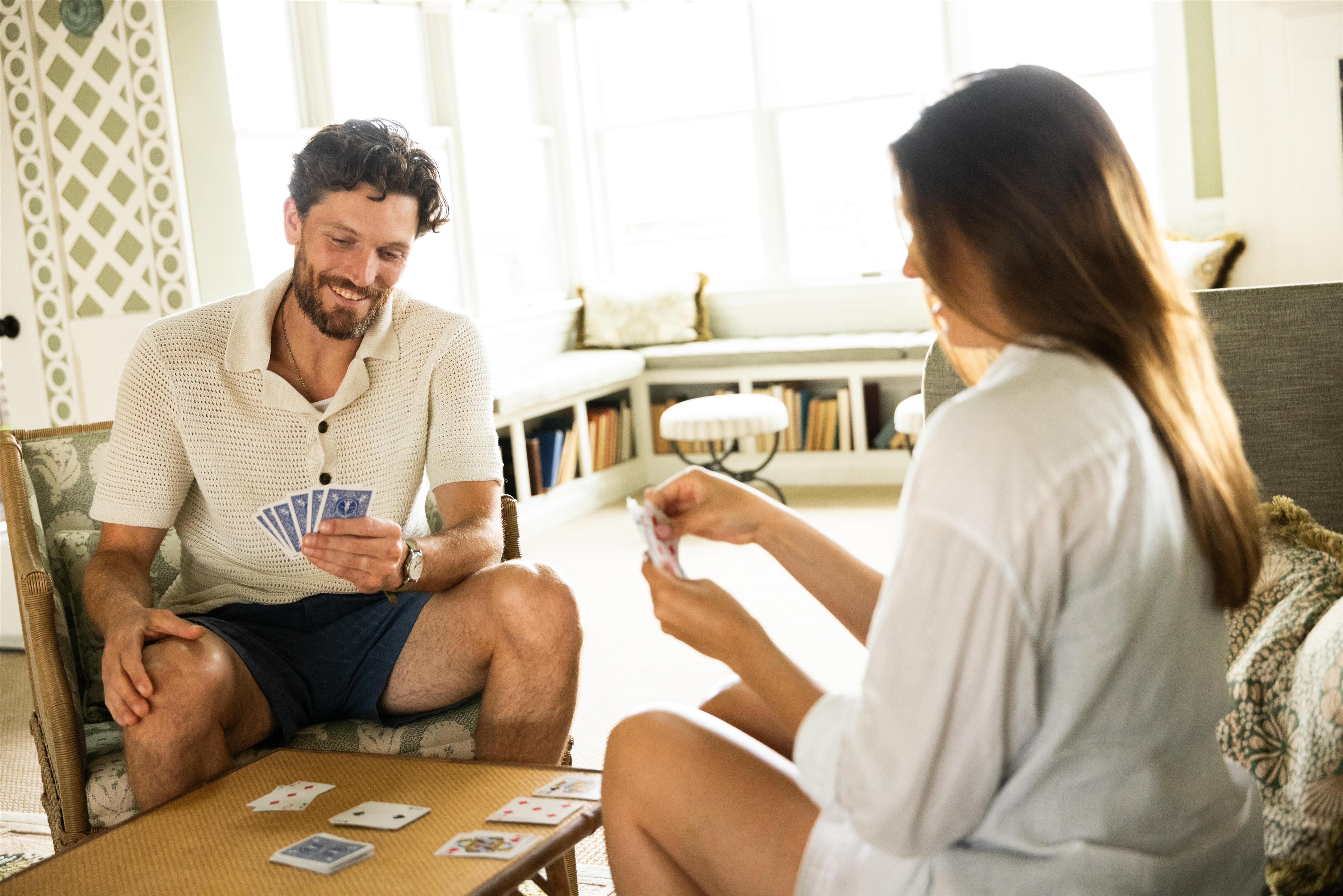 Couple playing cards in the Beach House | Sanderling Resort Residences