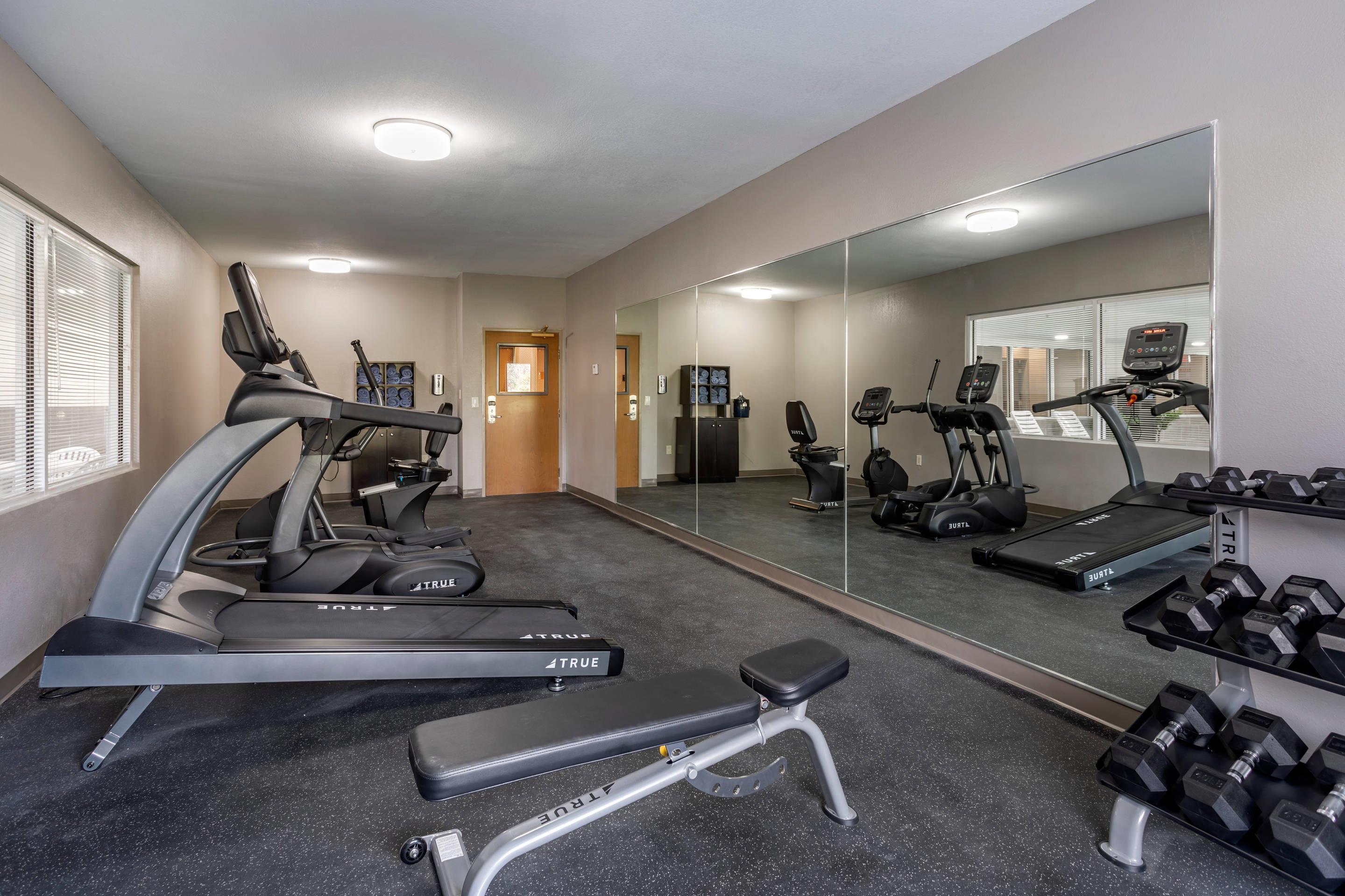 Exercise room with cardio equipment and weights