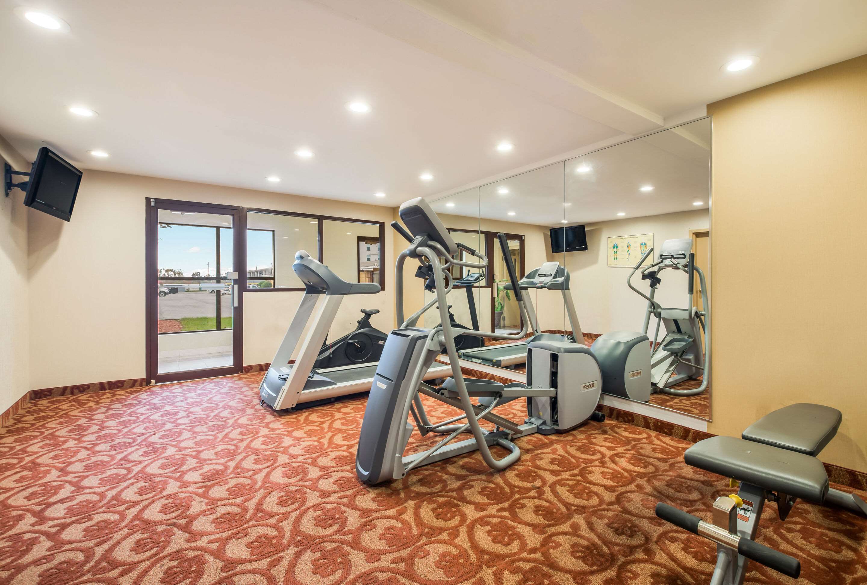 Exercise room with cardio equipment | Suburban Studios Buffalo Airport