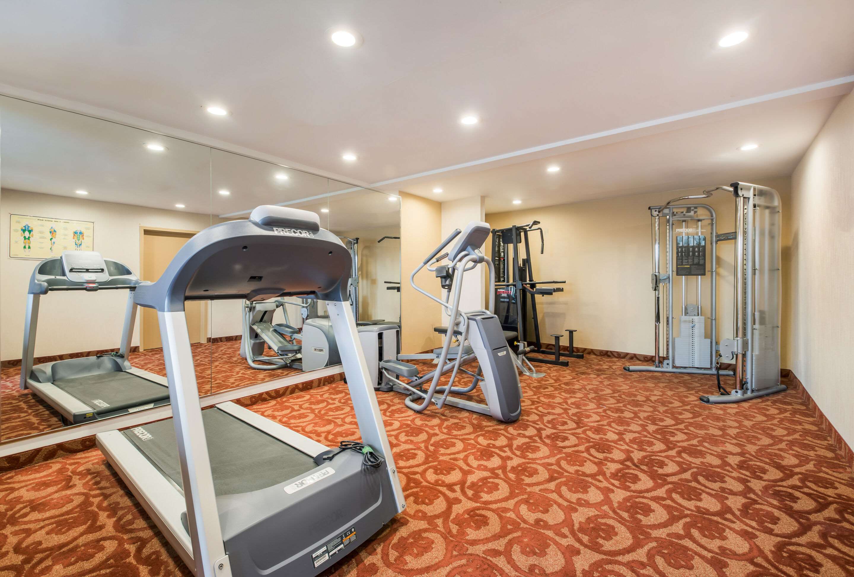Exercise room with cardio equipment | Suburban Studios Buffalo Airport