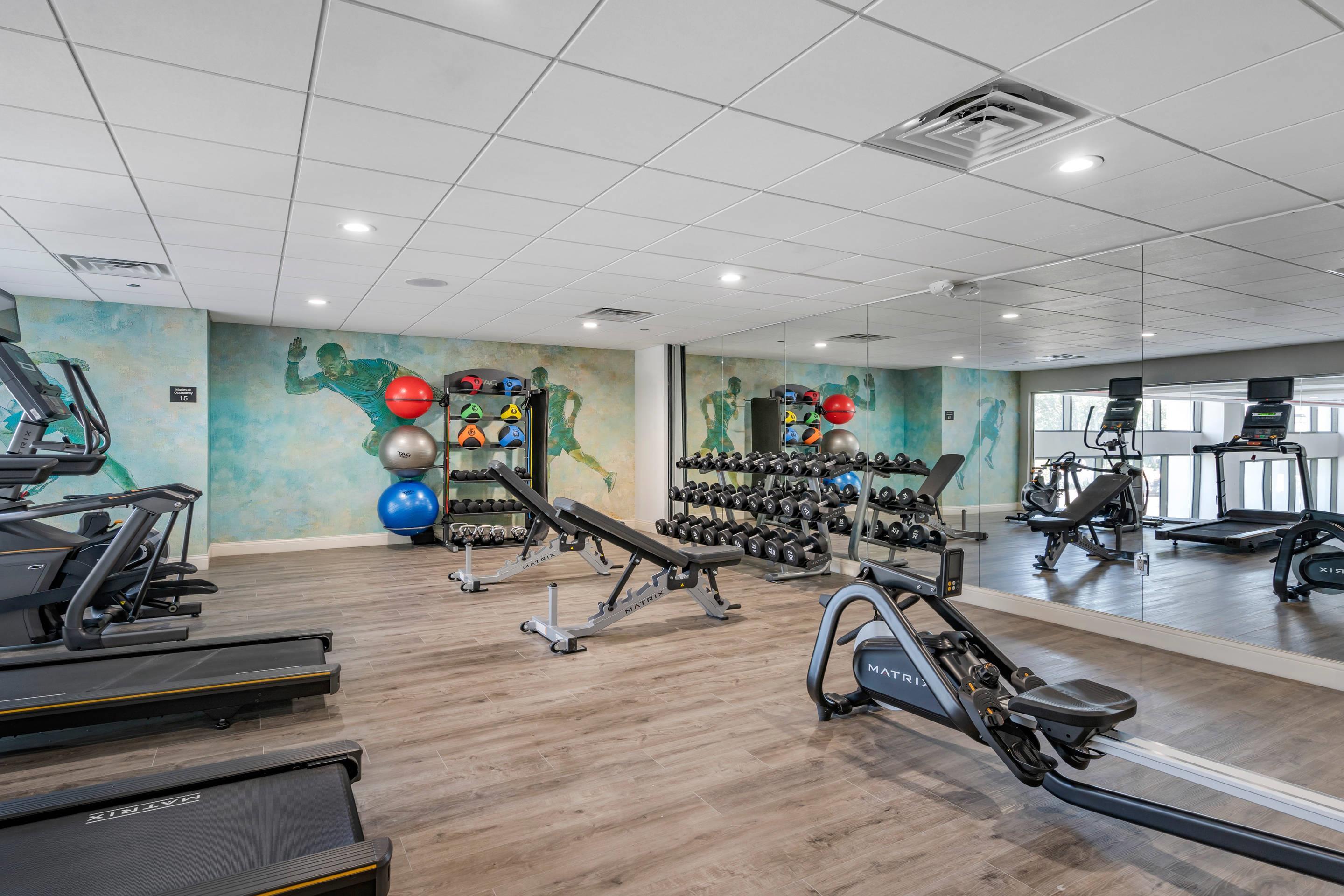 Exercise room with cardio equipment and weights | Cambria Hotel Orlando Universal Blvd