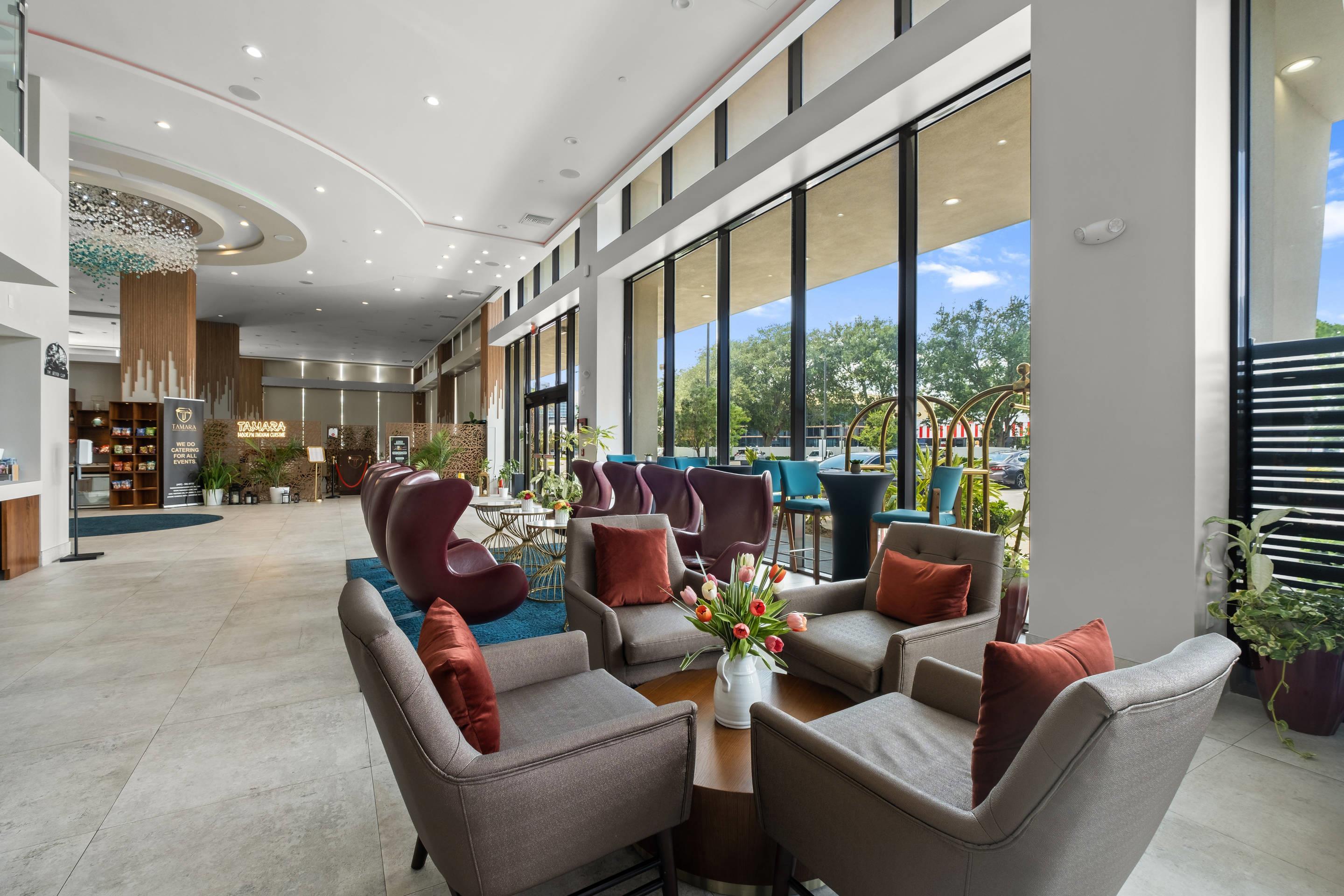 Spacious lobby with sitting area | Cambria Hotel Orlando Universal Blvd